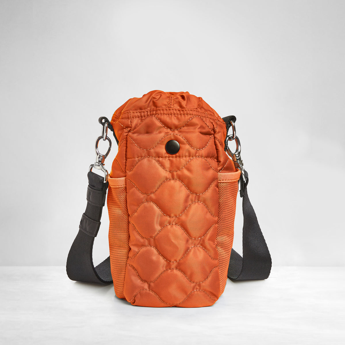 shortyLOVE bea sling bag in orange; back view against grey background.