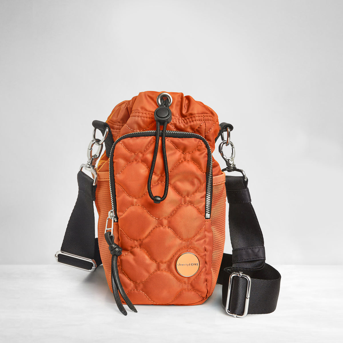 shortyLOVE bea sling bag in orange; front view against grey background.
