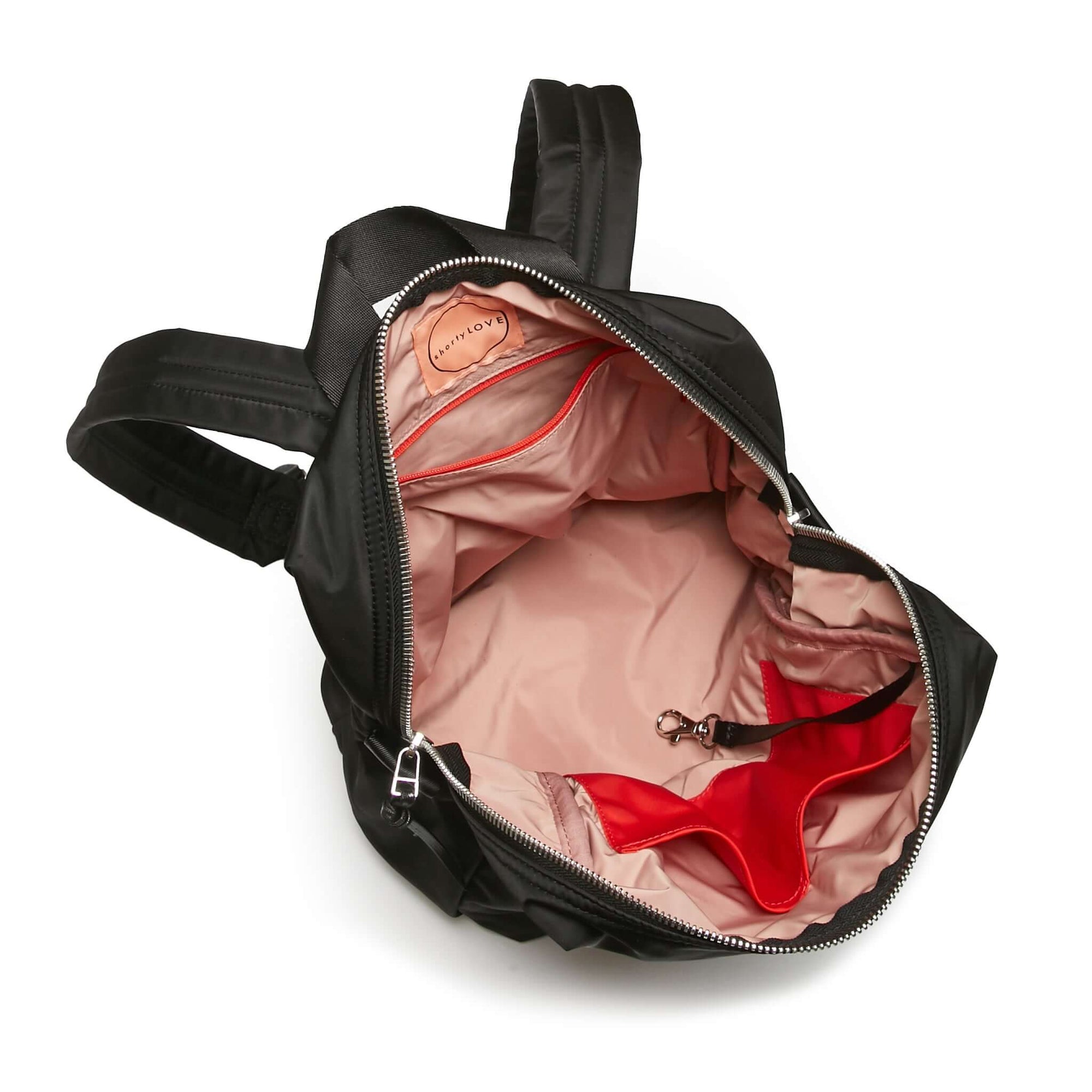 shortyLOVE ace small backpack in black; top-down view showing interior pink lining against white background.