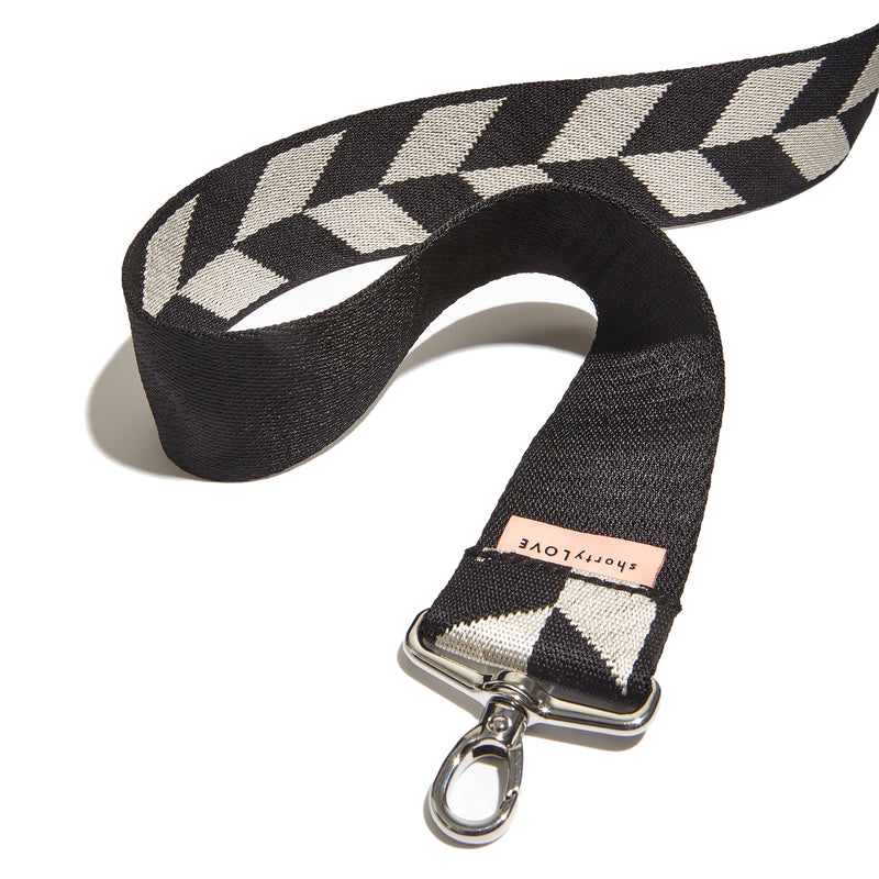 shortyLOVE boardwalk strap in arrow design in black/cream; top view open against white background.