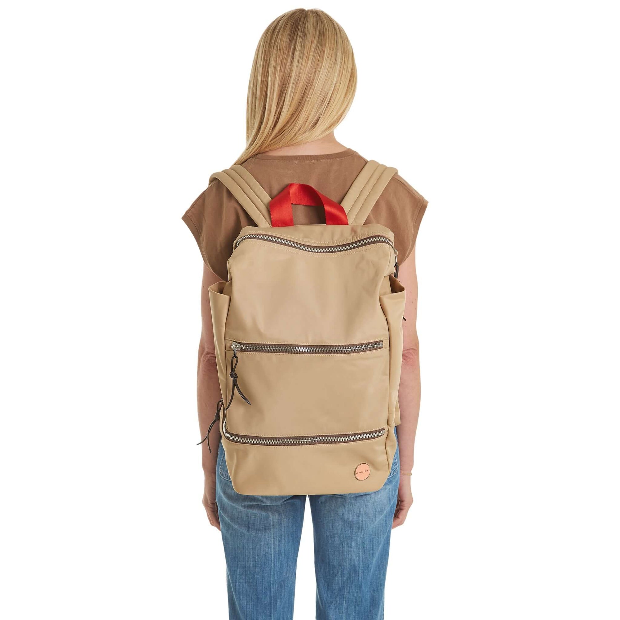 shortyLOVE boxer backpack in khaki; on model on back in mocha t-shirt and jeans against white background.