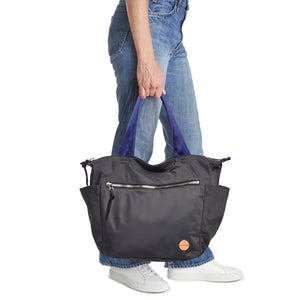 shortyLOVE tillie tote bag in charcoal; hand held by model in jeans against white background.