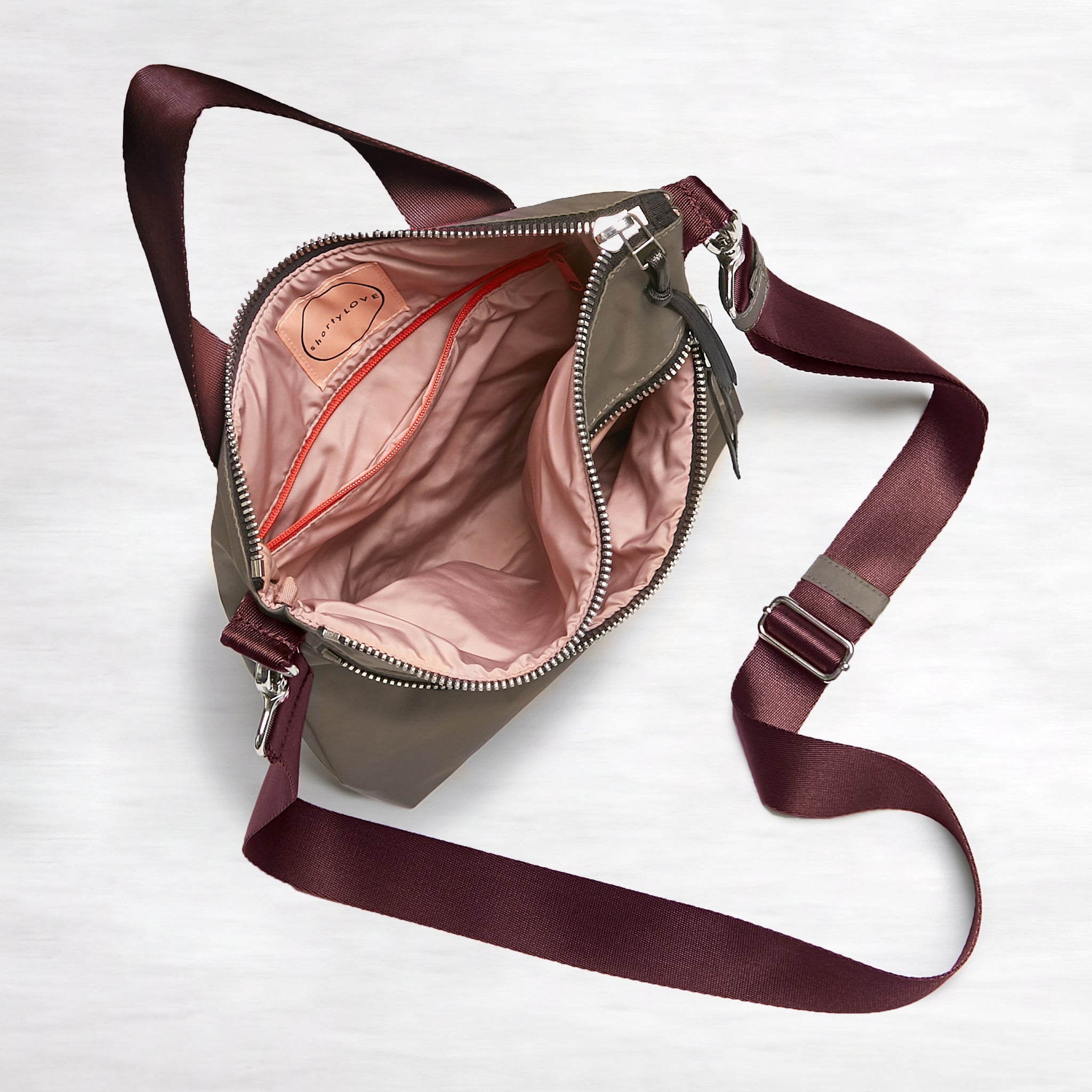 shortyLOVE amuse medium sized crossbody bag in mocha; top-down view showing interior mocha lining against white background.