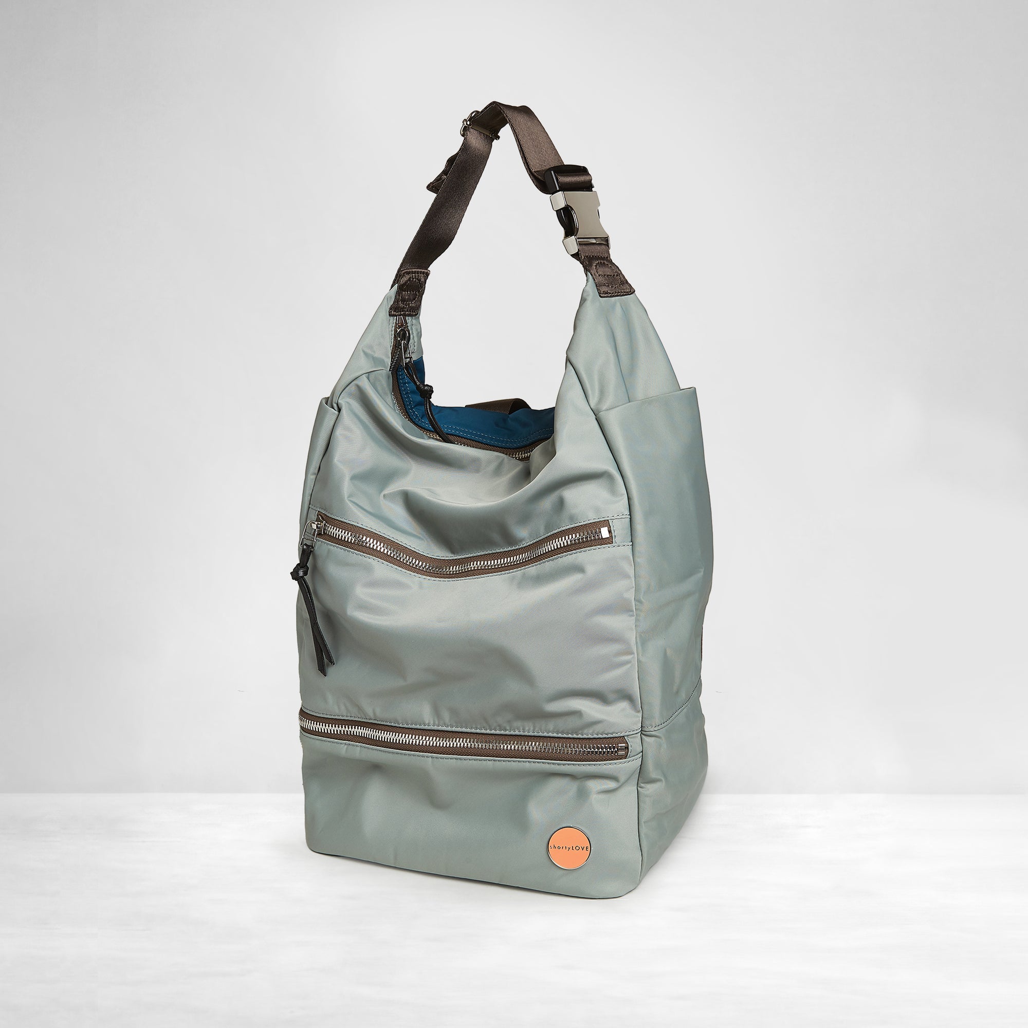 shortyLOVE boxer backpack in slate/teal; side angle view against white background.