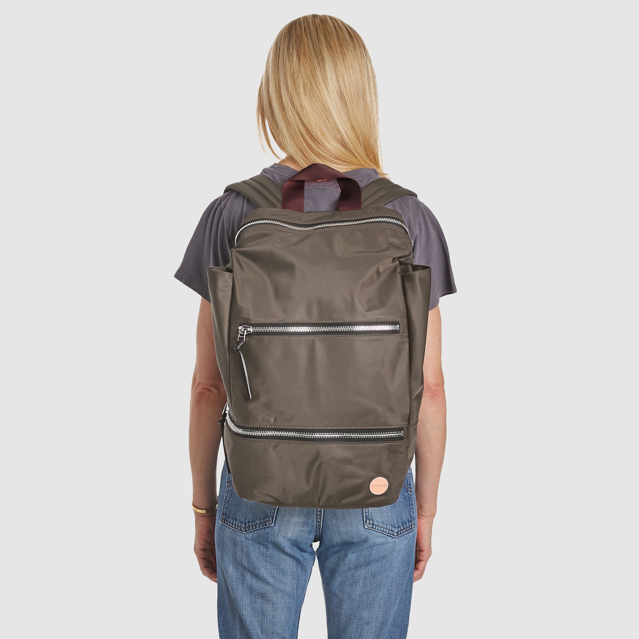 shortyLOVE boxer backpack in mocha; on model on back in grey t-shirt and jeans against white background.
