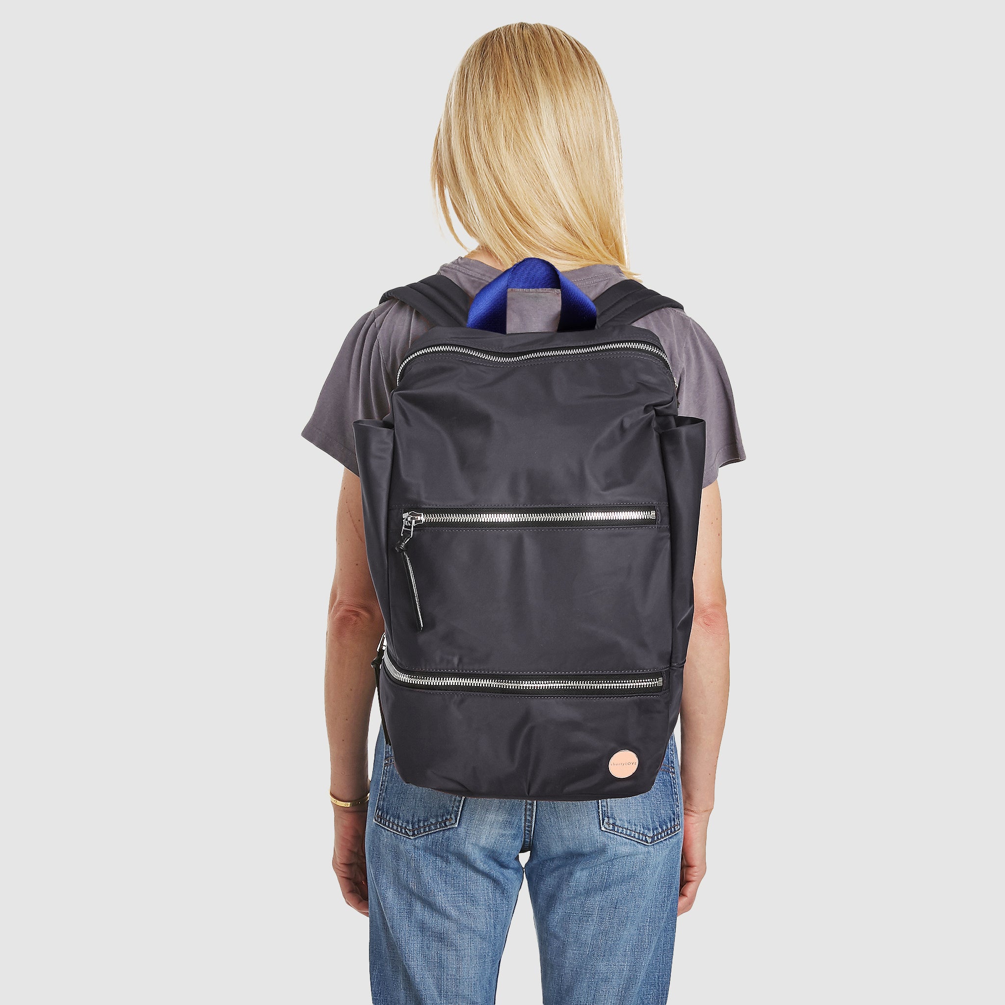 shortyLOVE boxer backpack in charcoal; on model over shoulder in grey t-shirt and jeans against white background.