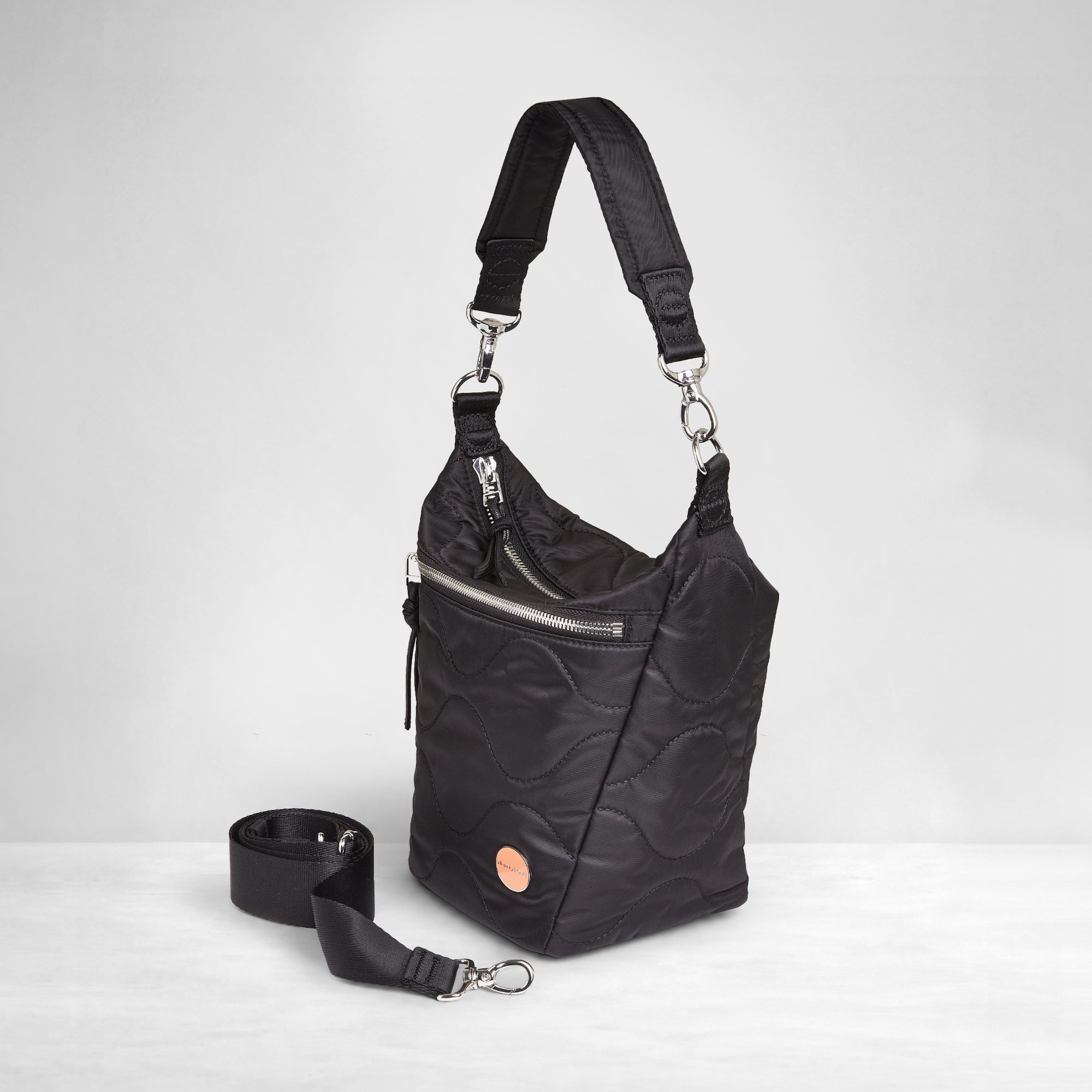 shortyLOVE marcel crossbody bucket bag in black; side view against white background.