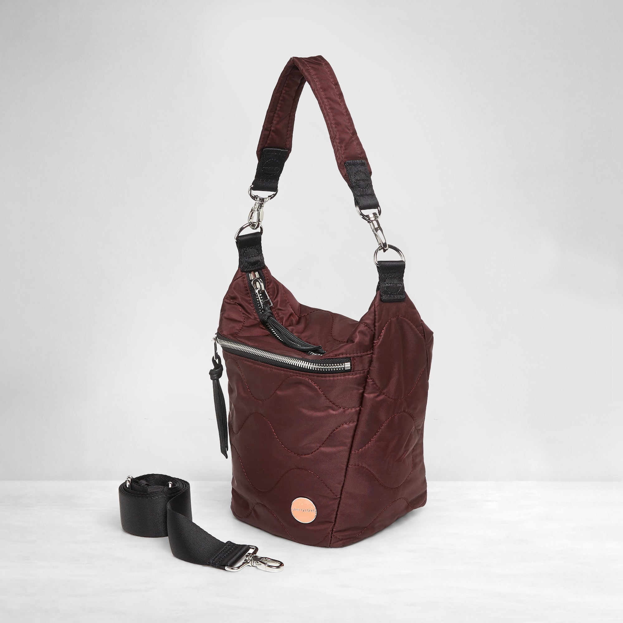 shortyLOVE marcel crossbody bucket bag in bordeaux; side view against white background.