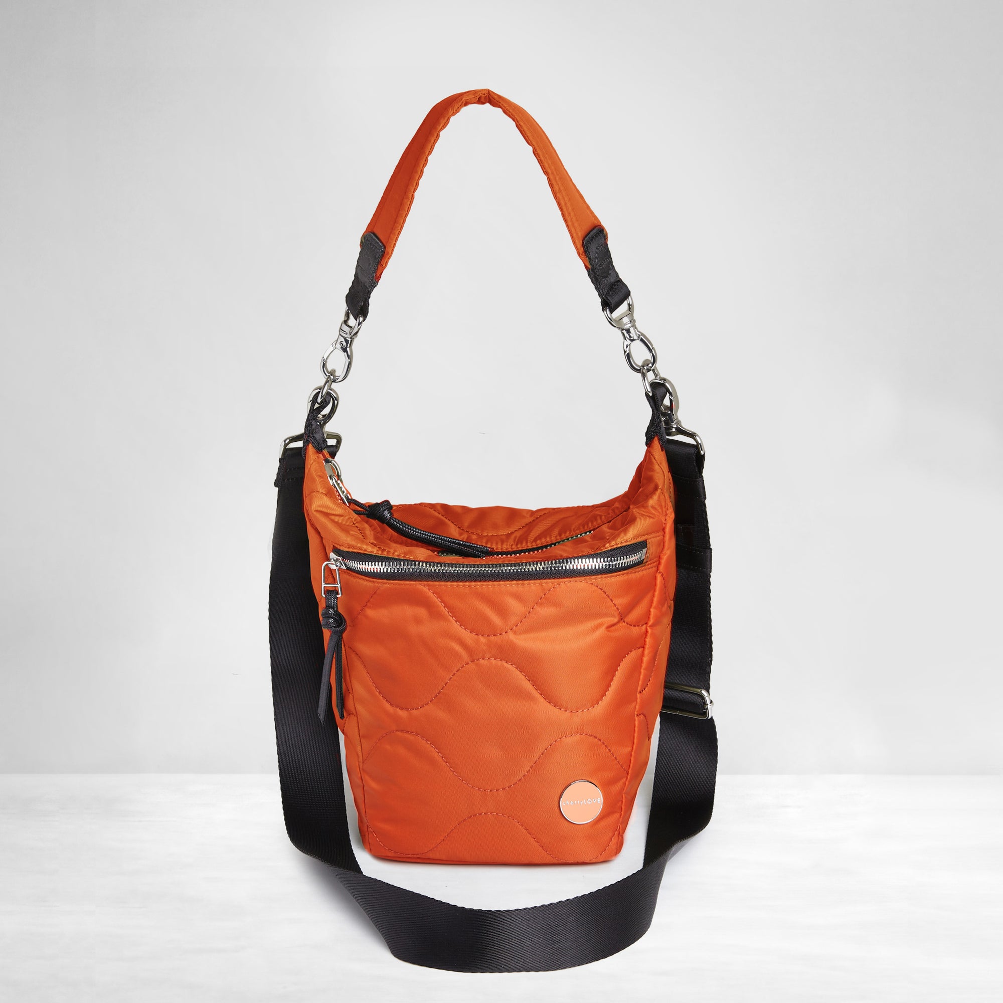 shortyLOVE marcel crossbody bucket bag in orange; front view against white background.