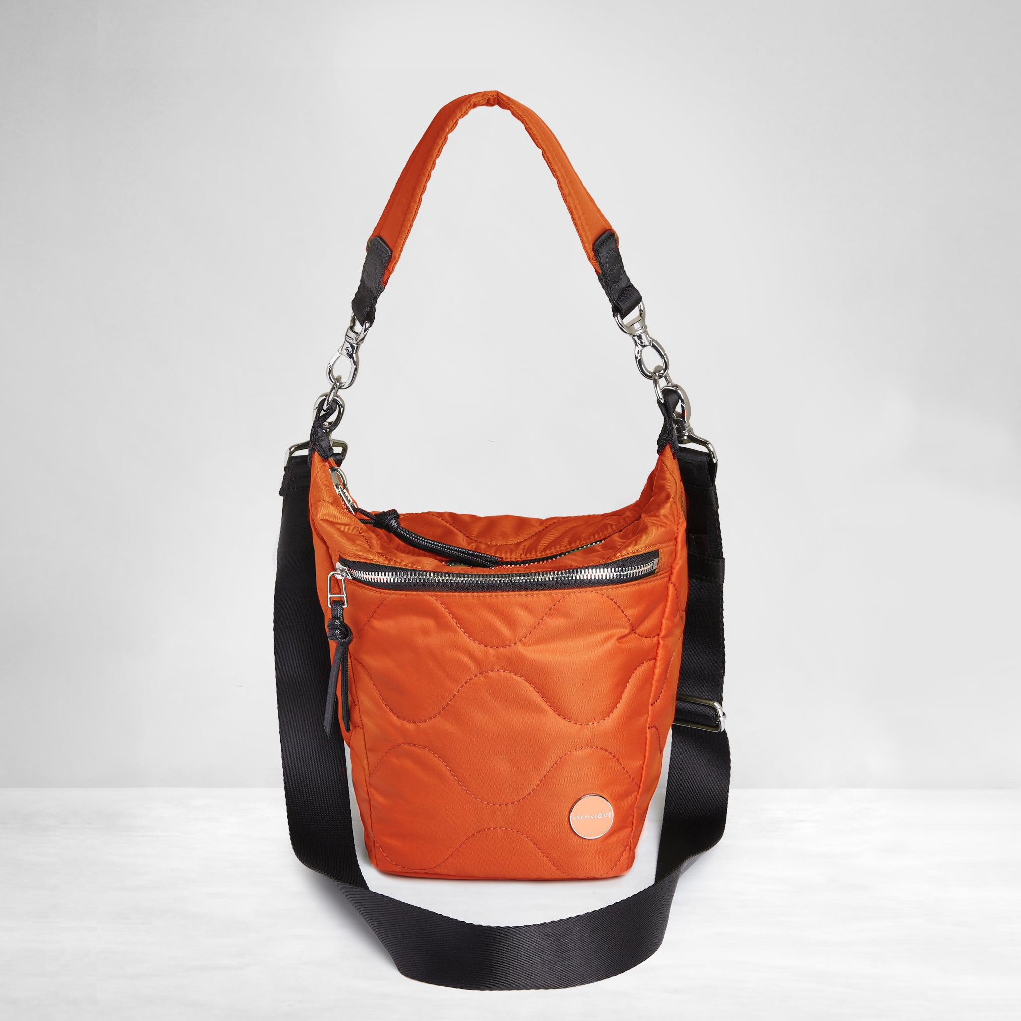 shortyLOVE marcel crossbody bucket bag in orange; front view against white background.