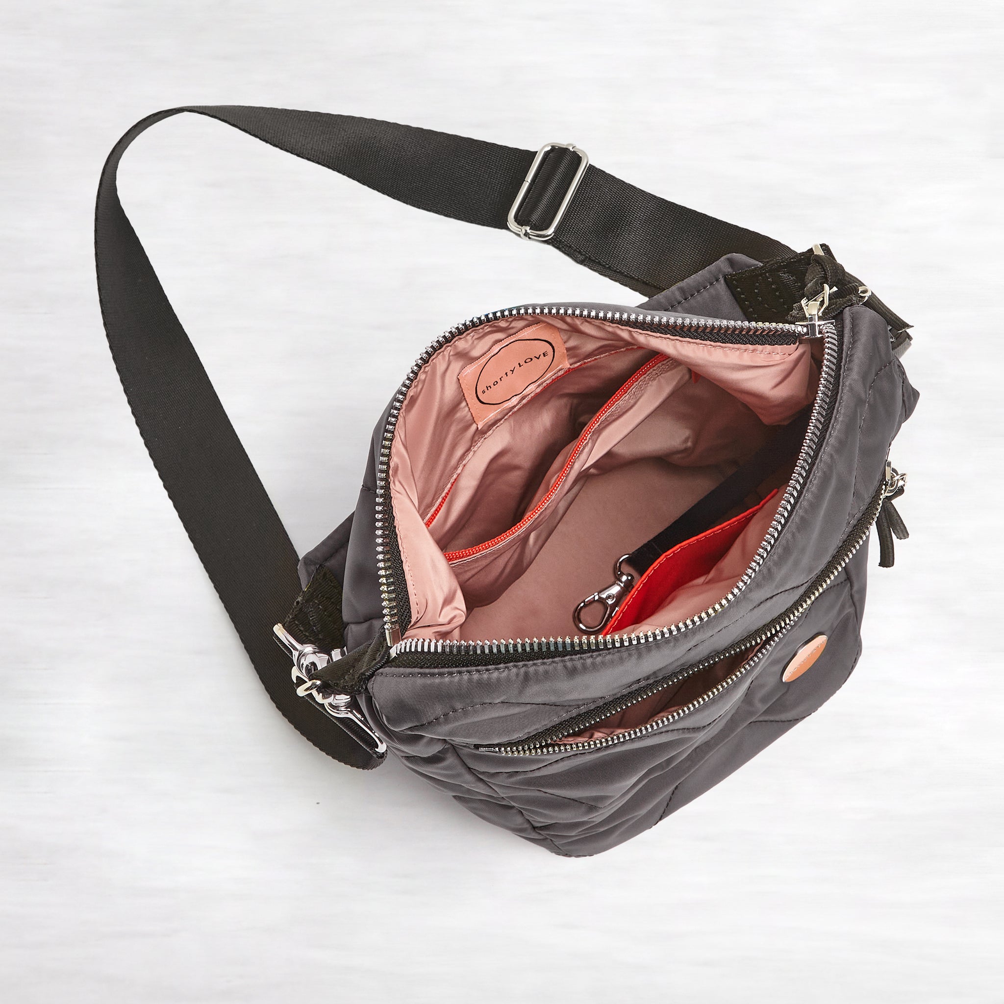 shortyLOVE marcel crossbody bucket bag in pewter; top-down view showing interior blush lining against white background.