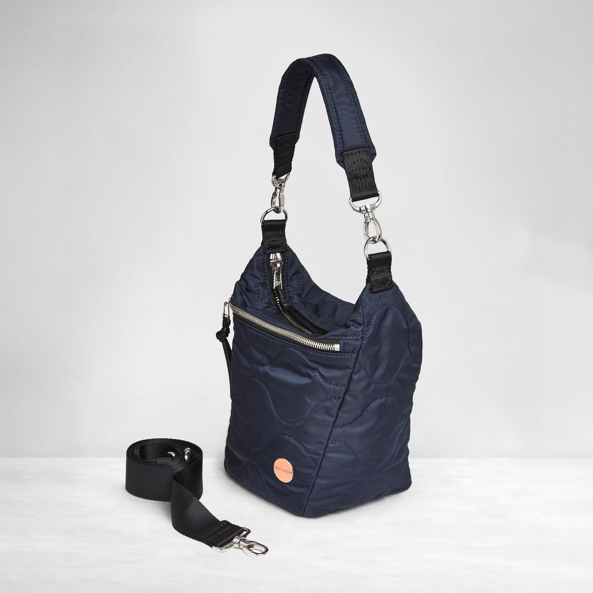 shortyLOVE marcel crossbody bucket bag in midnight; side view against white background.