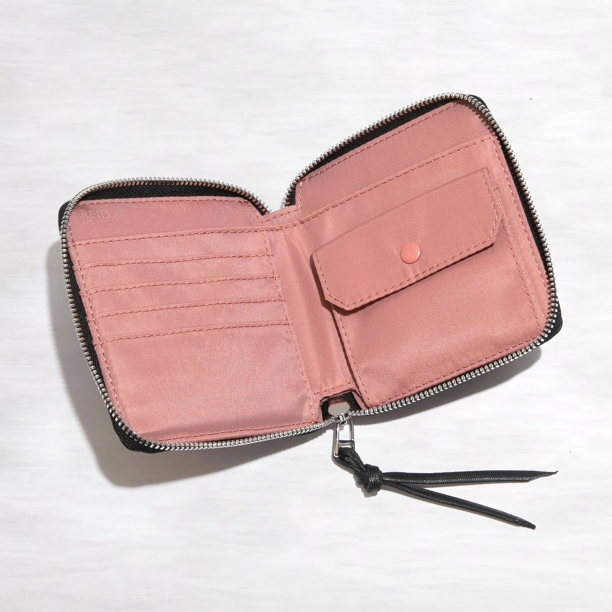 shortyLOVE merchant small wallet in navy; top-down view showing interior pink lining against white background.