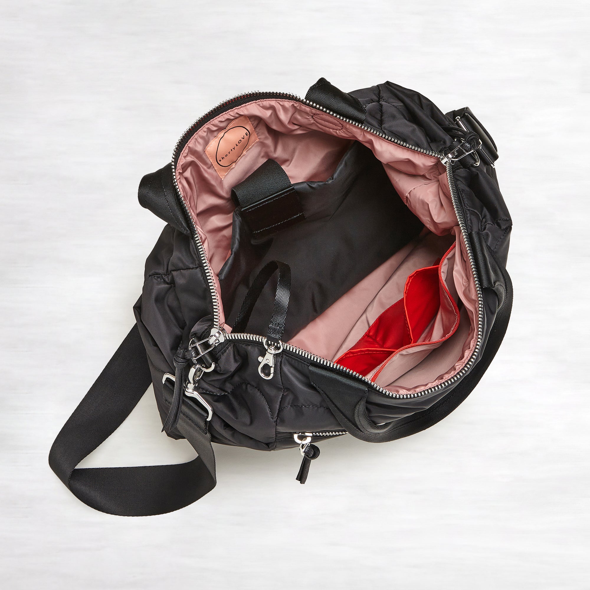shortyLOVE ranger large tote bag in black; top-down view showing interior blush lining against white background.