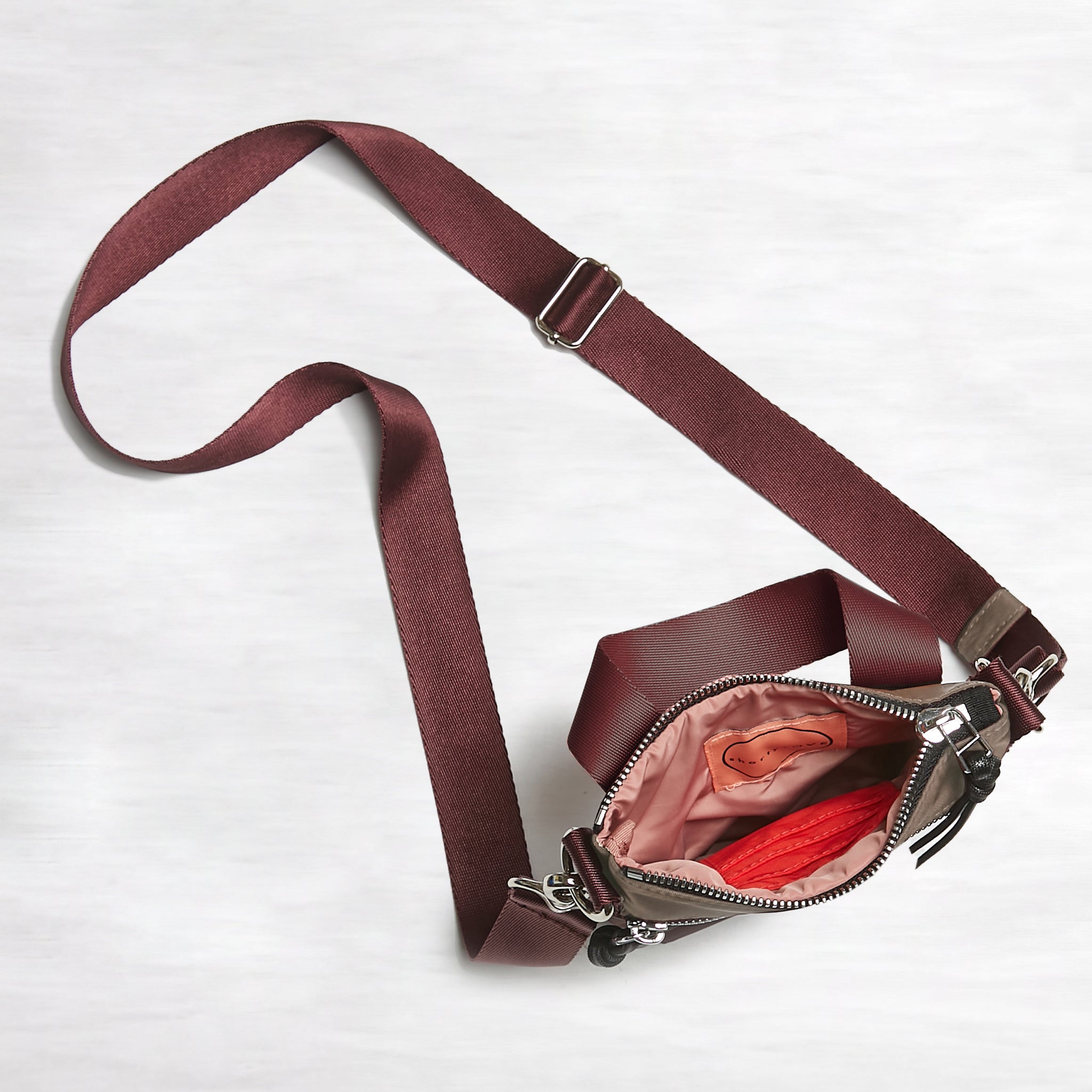 shortyLOVE shorthand small crossbody bag in mocha; top-down view showing interior mocha lining against white background.
