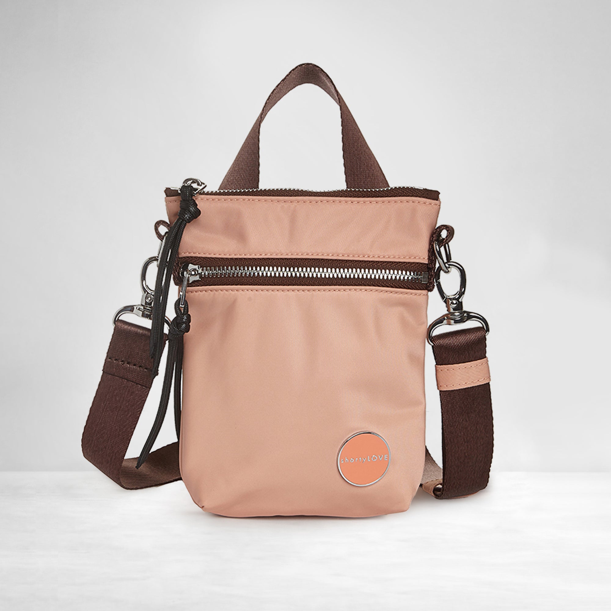shortyLOVE shorthand small crossbody bag in dusty peach; front view against white background.
