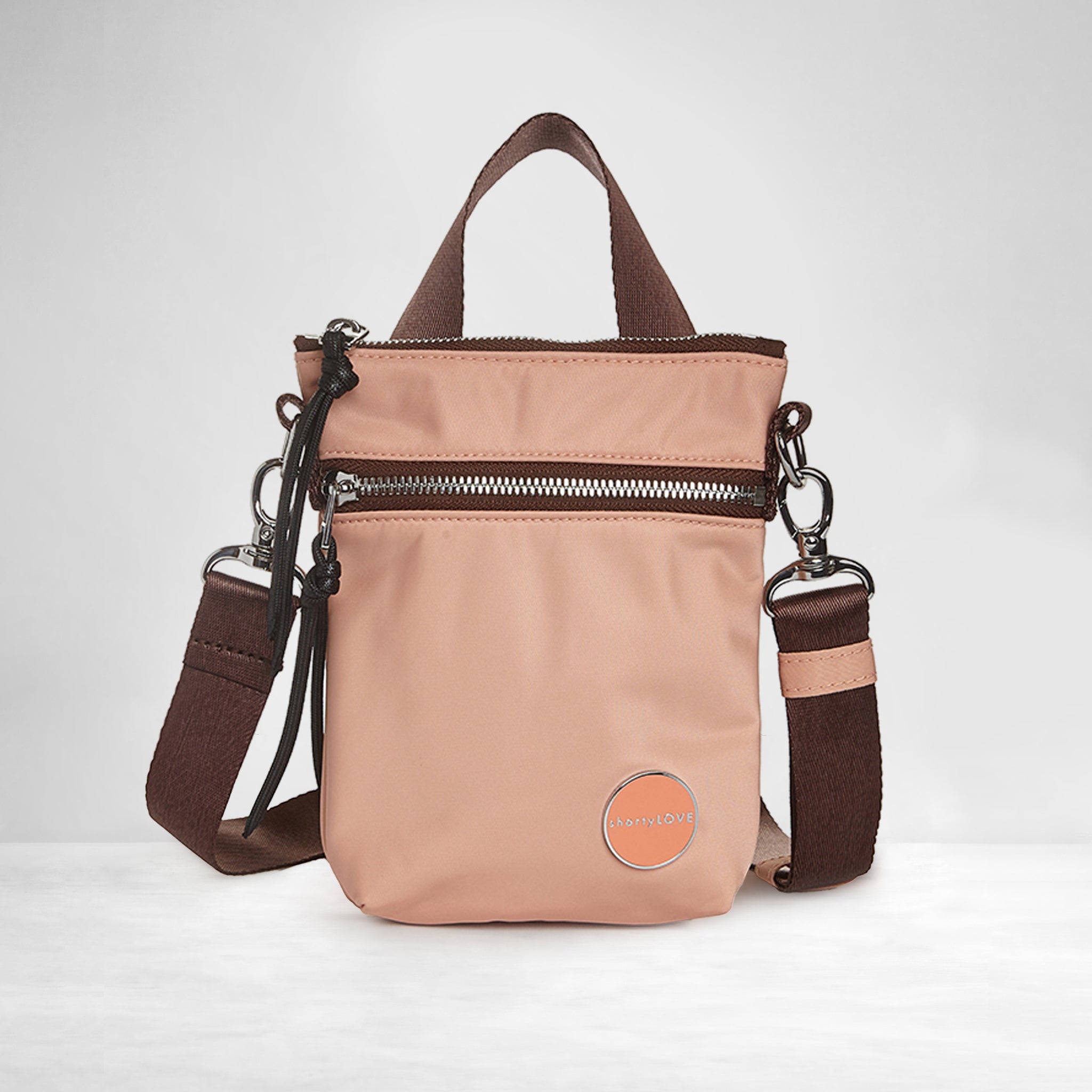 shortyLOVE shorthand small crossbody bag in dusty peach; front view against white background.