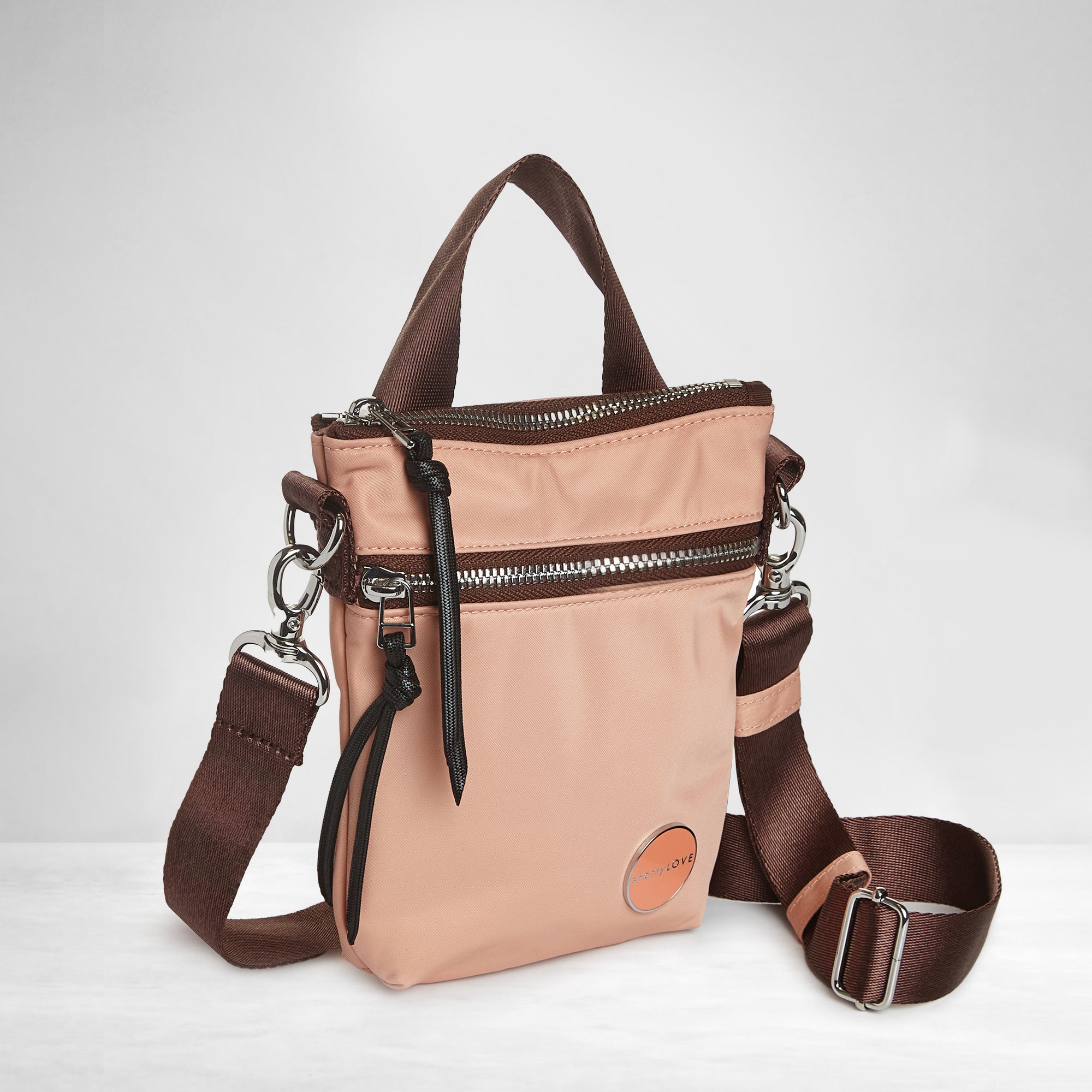 shortyLOVE shorthand small crossbody bag in dusty peach; side angle view against white background.