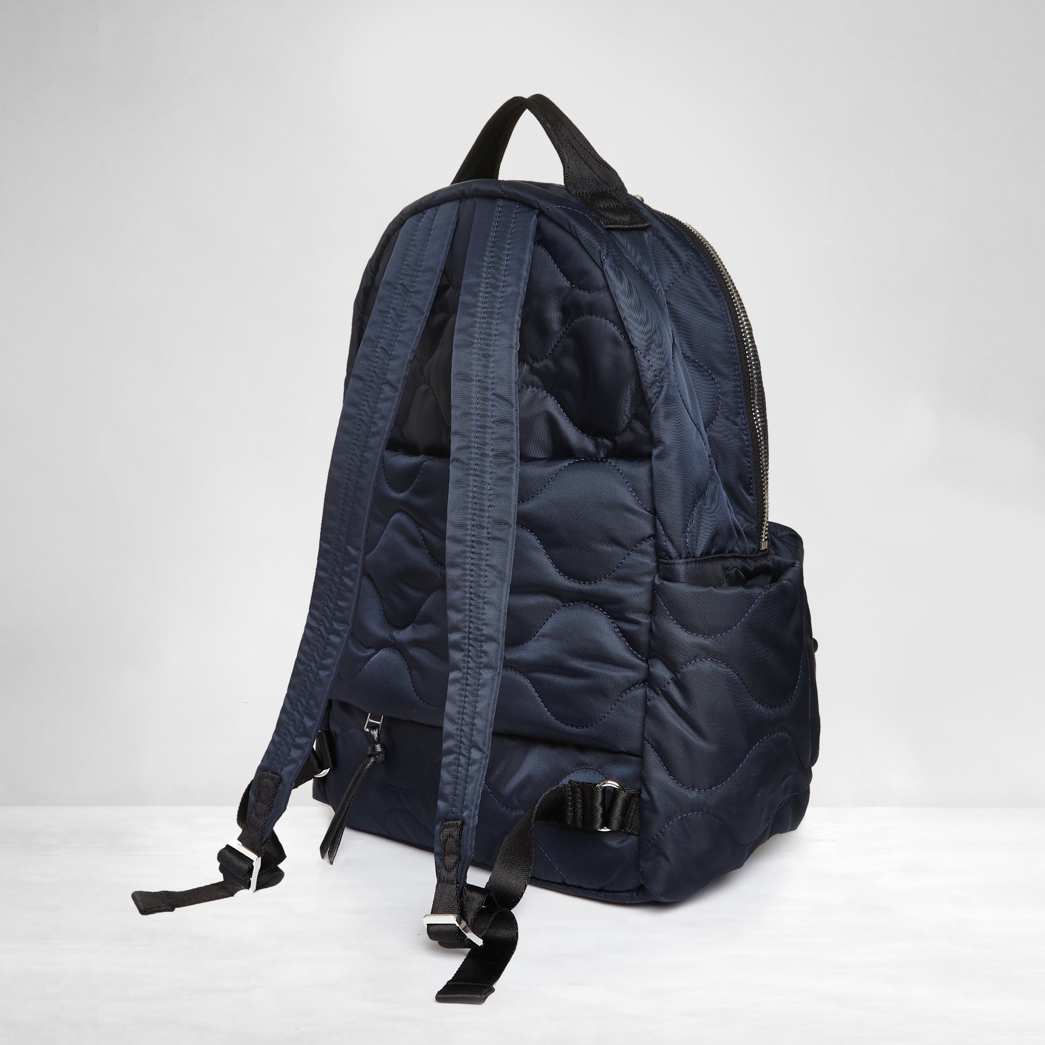 shortyLOVE tate backpack in midnight; back view against white background.