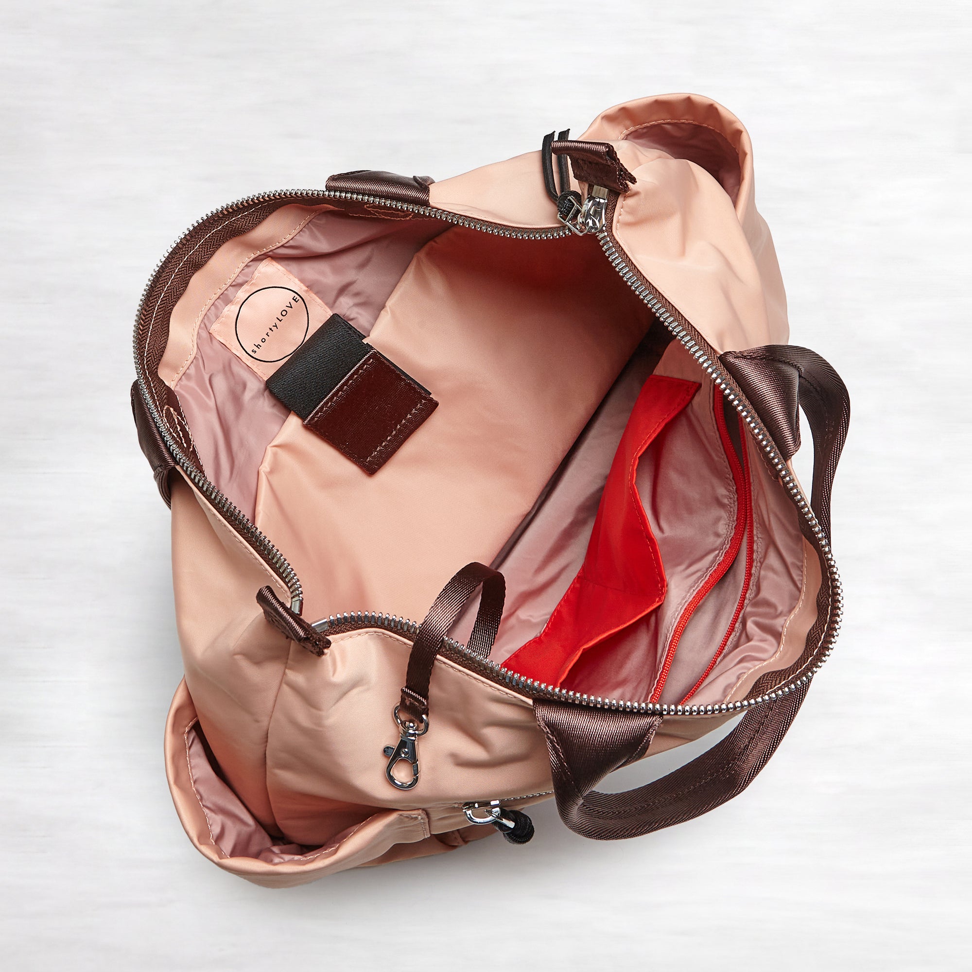 shortyLOVE tillie tote bag in dusty peach; top-down view showing interior blush/red lining against white background.