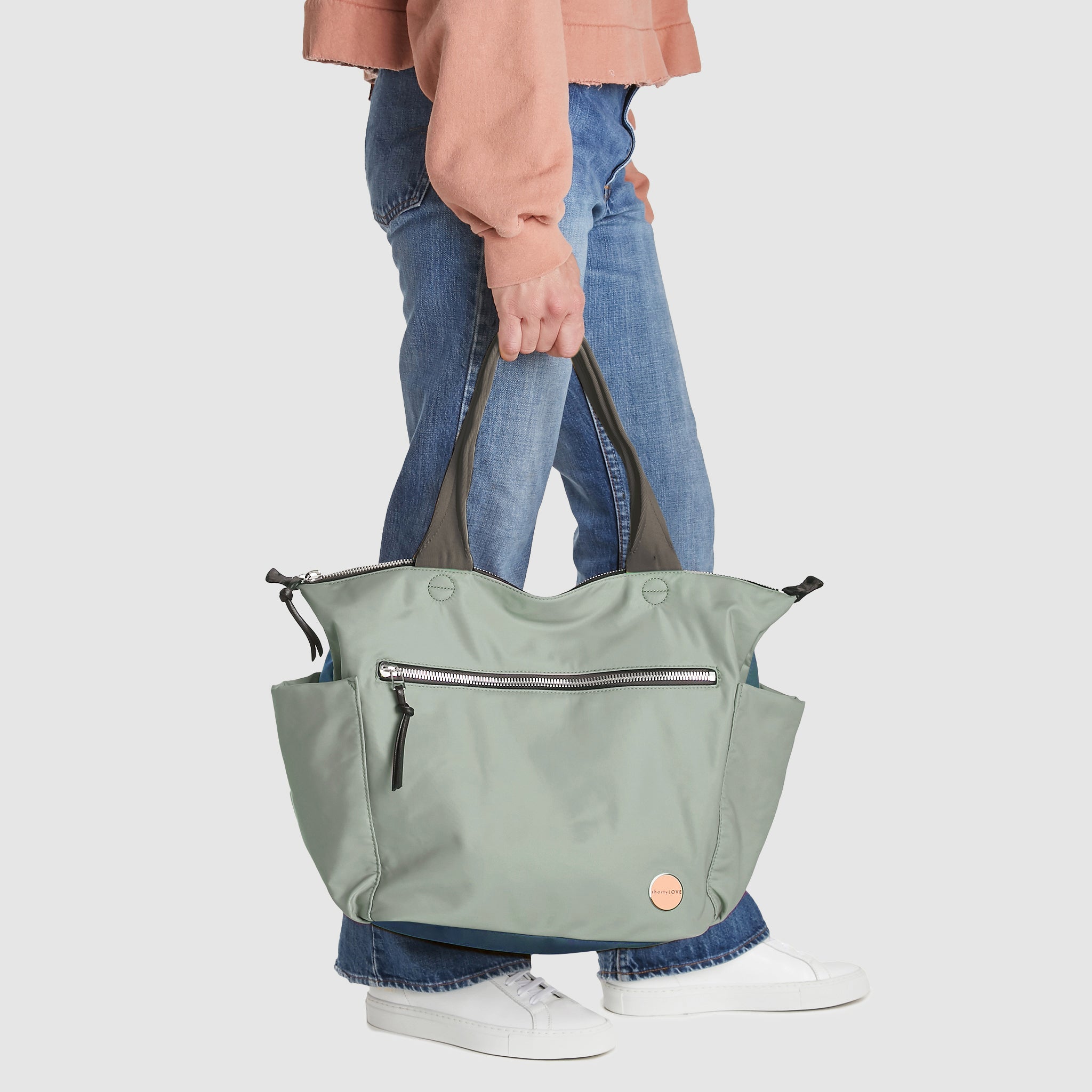 shortyLOVE tillie tote bag in slate/teal in hand of model in jeans against white background.