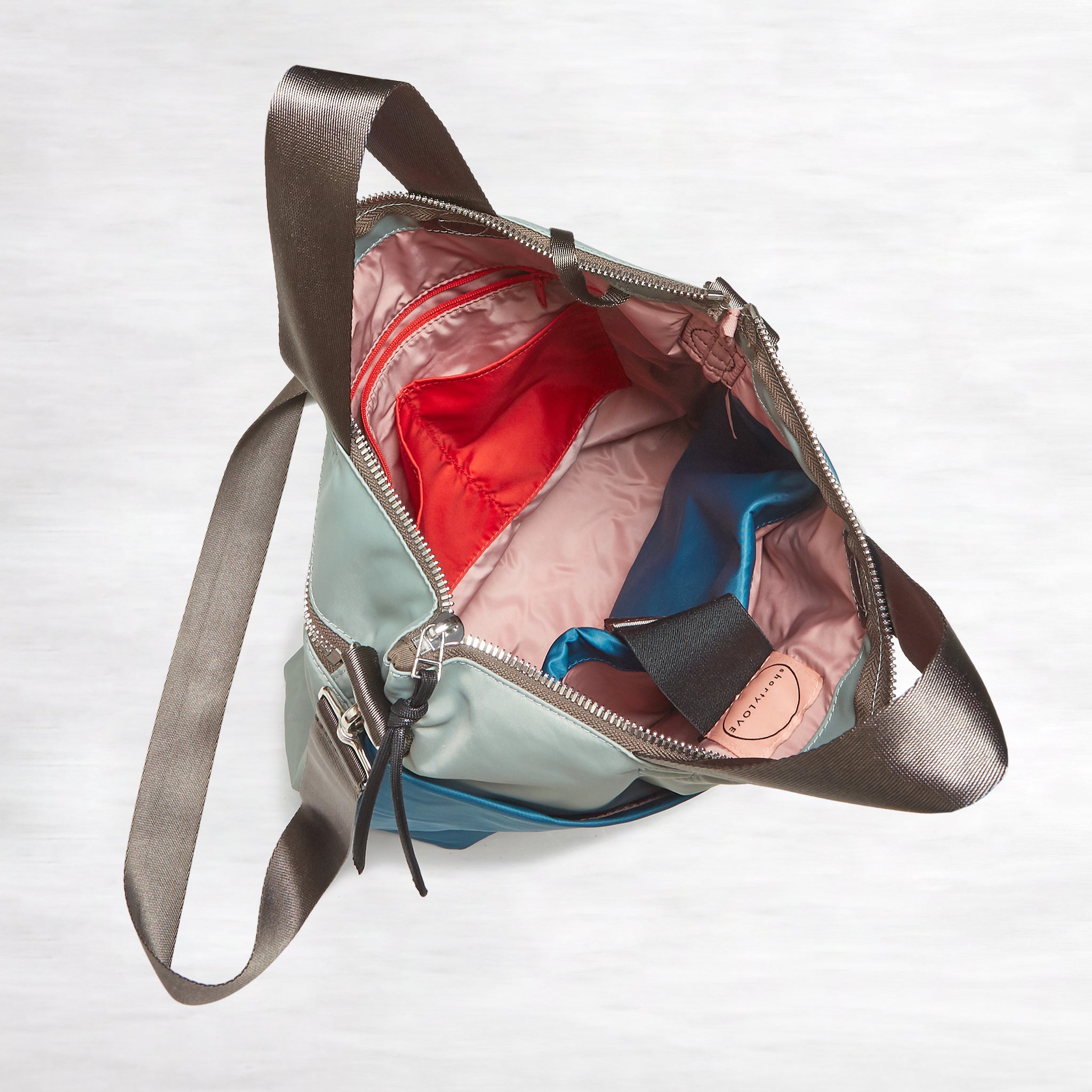 shortyLOVE wonder large crossbody/messenger bag in slate/teal; top-down view showing interior slate/teal lining against white background.