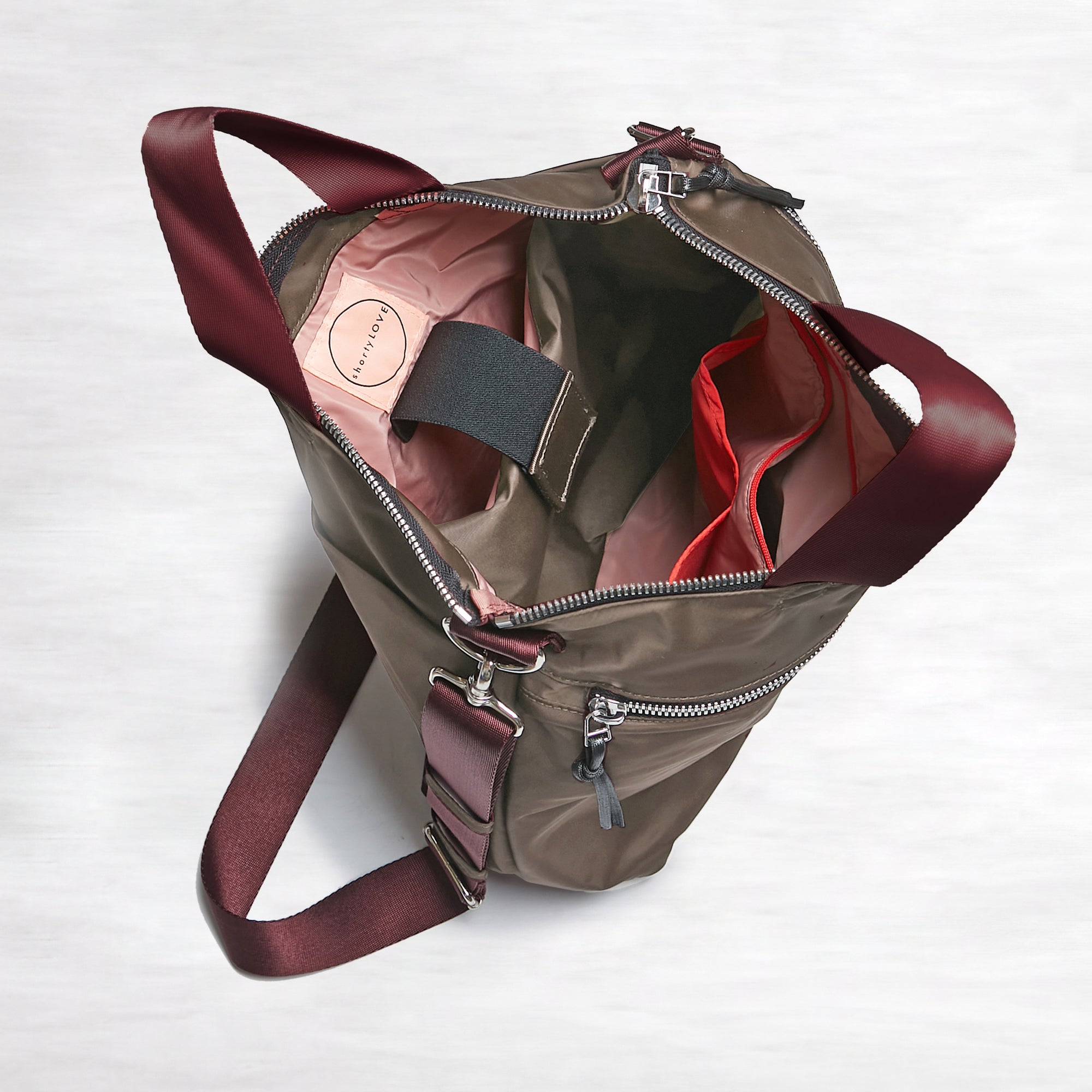 shortyLOVE wonder large crossbody/messenger bag in mocha; top-down view showing interior mocha lining against white background.
