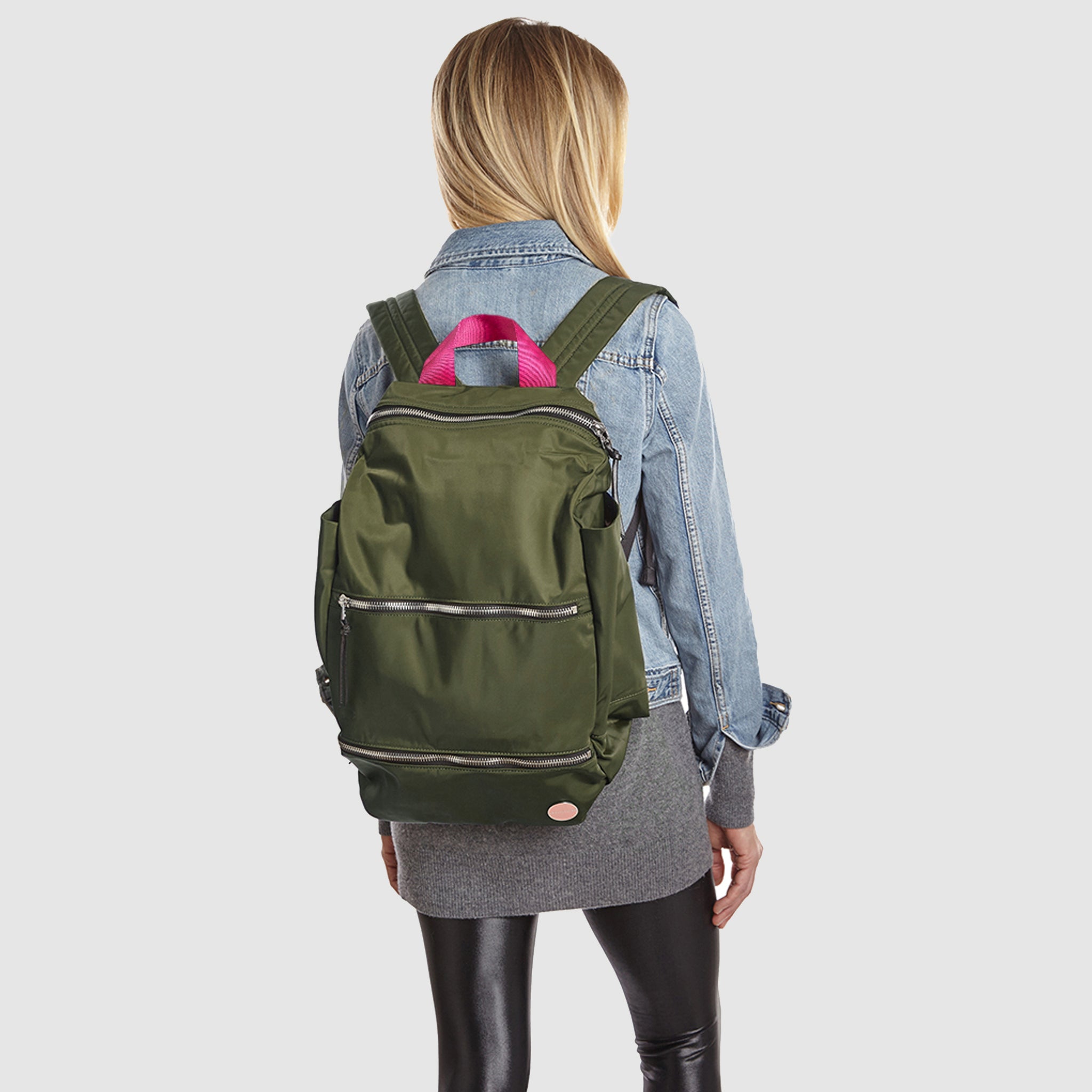 shortyLOVE boxer backpack bag in army green; on model in blue jean jacket and black leggings against white background.