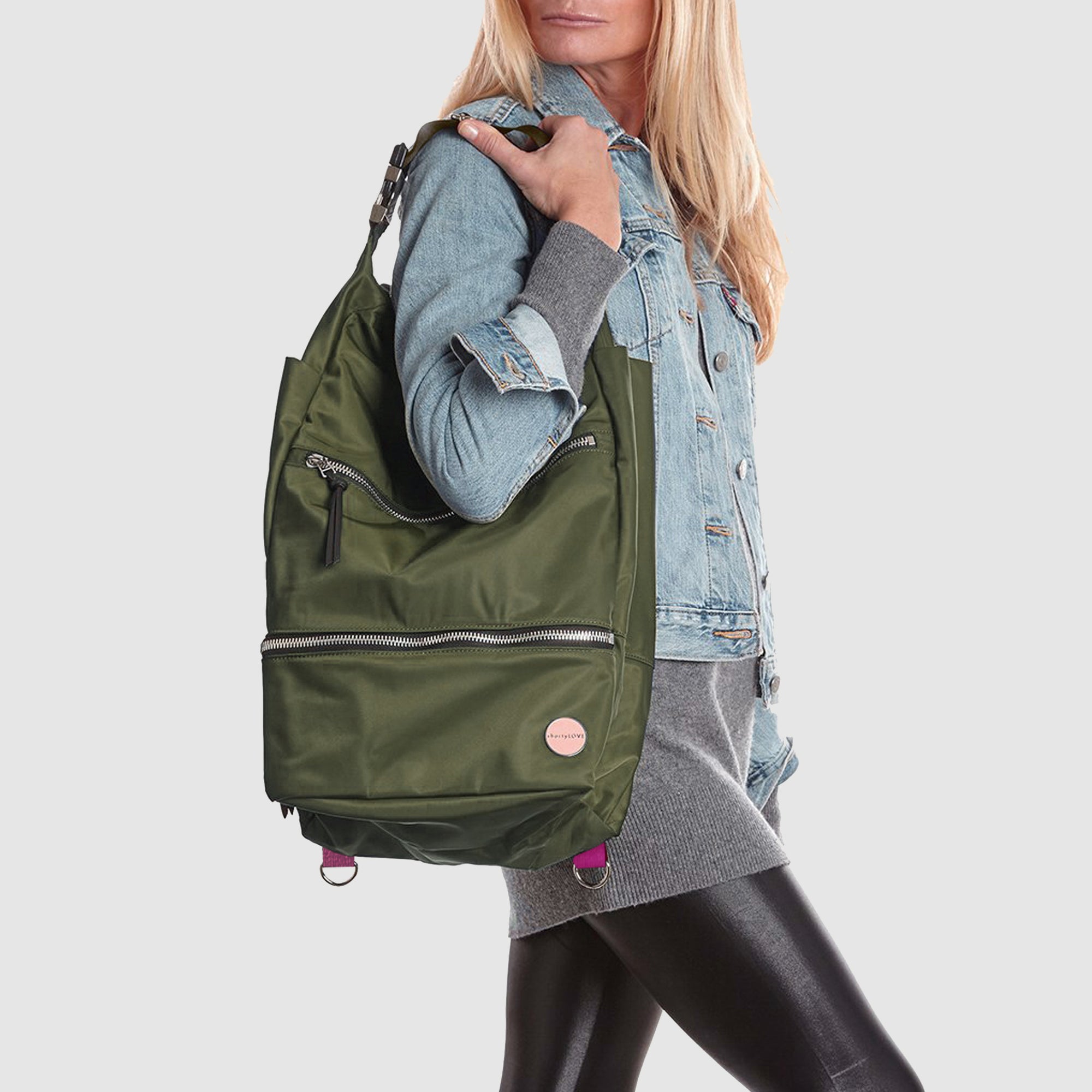 shortyLOVE boxer backpack bag in army green; on model in blue jean jacket and black leggings against white background.