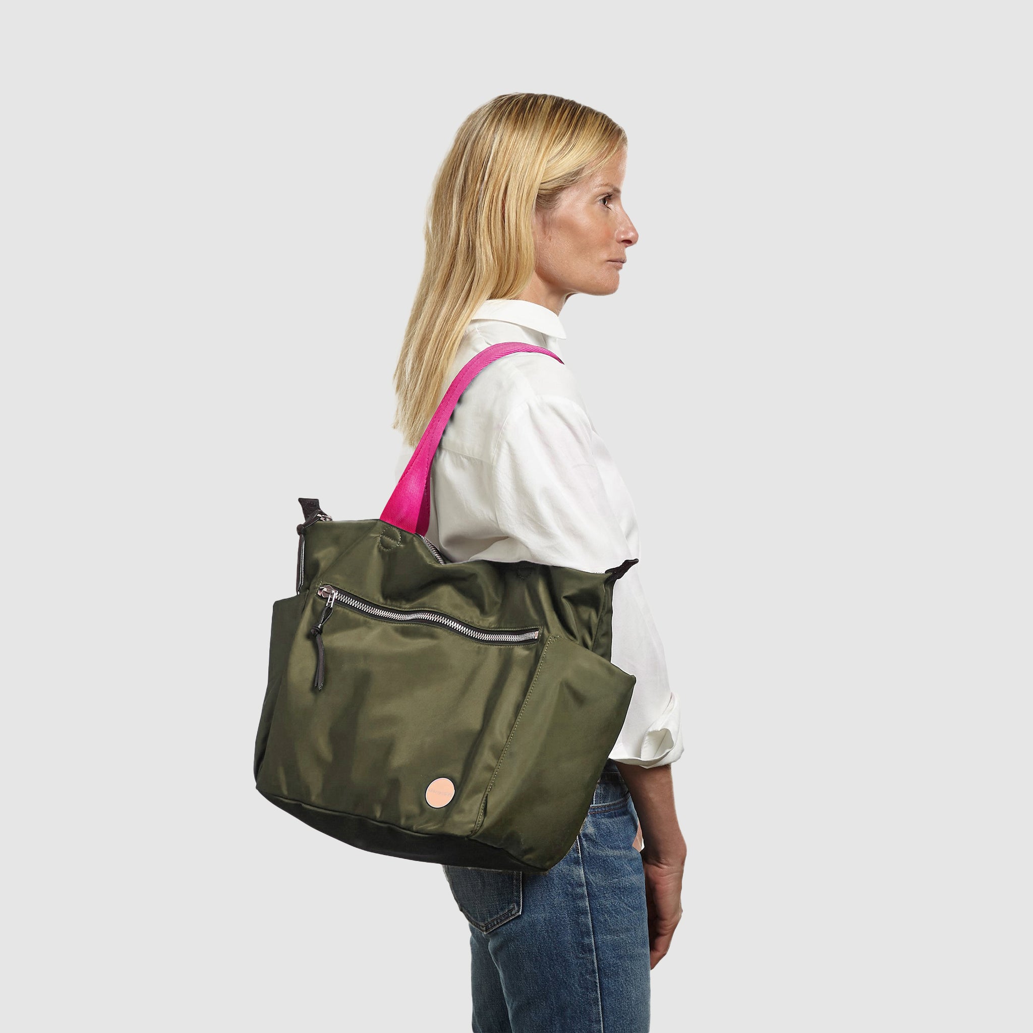 shortyLOVE tillie tote bag in army green; on model in white button down shirt and jeans against white background.