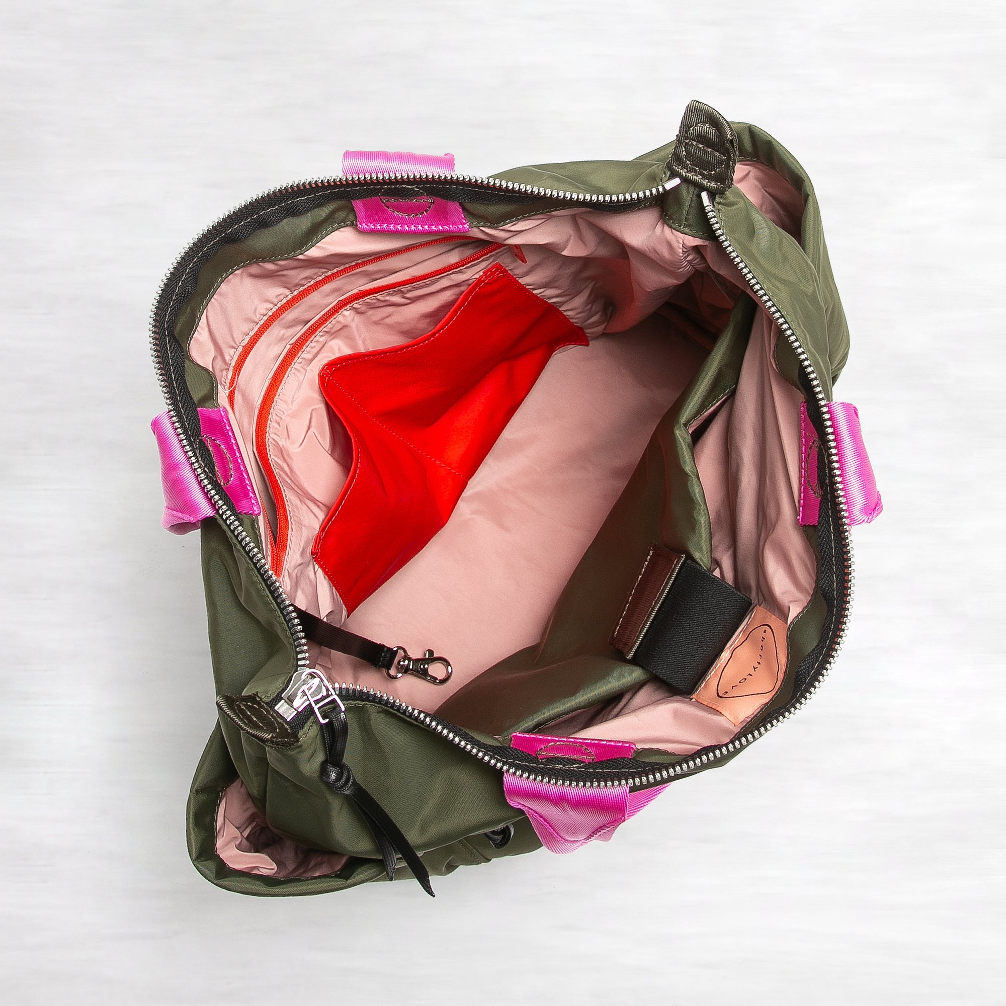 shortyLOVE tillie tote bag in army green; top-down view showing interior pink lining against white background.