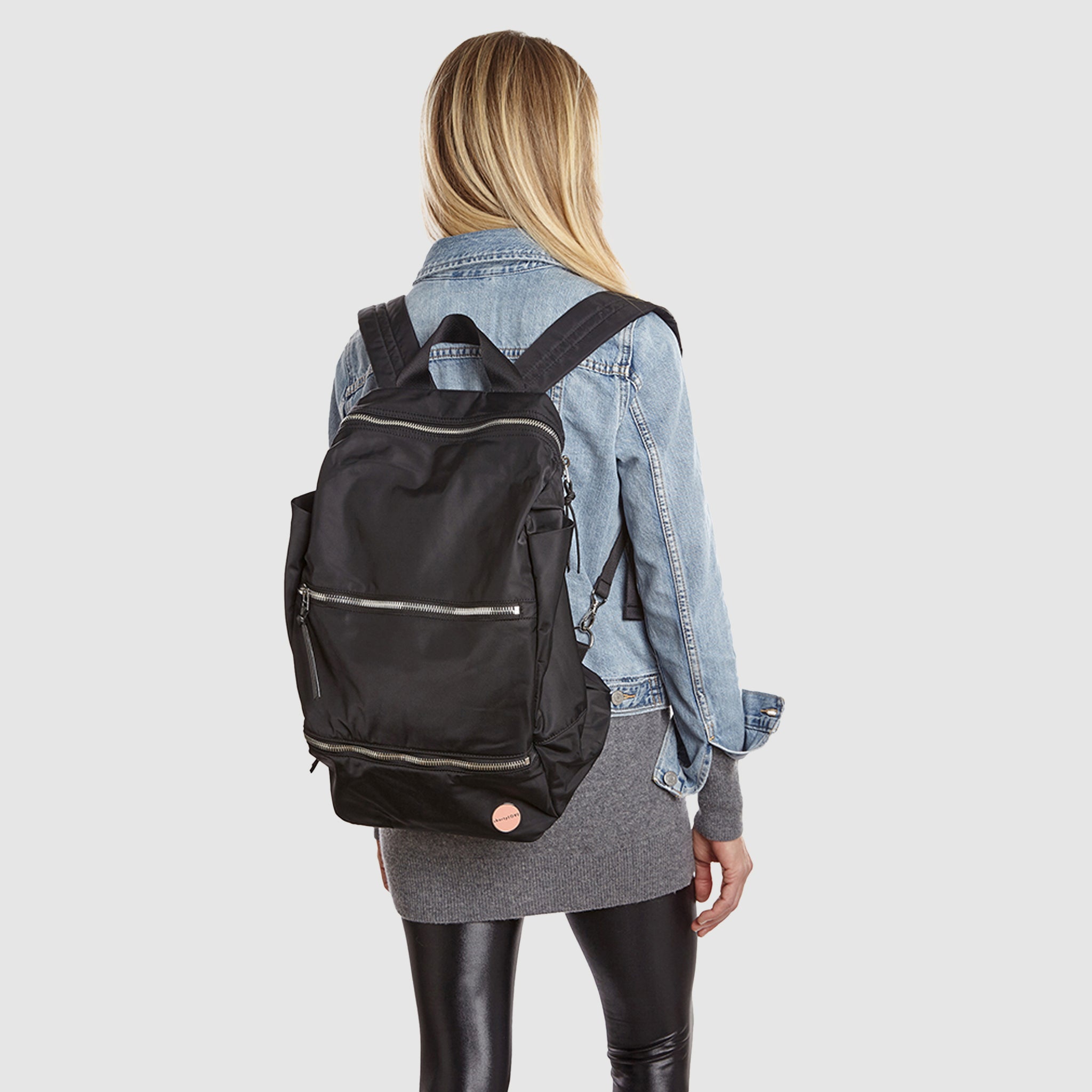shortyLOVE boxer backpack bag in black; on model in blue jean jacket and black leggings against white background.