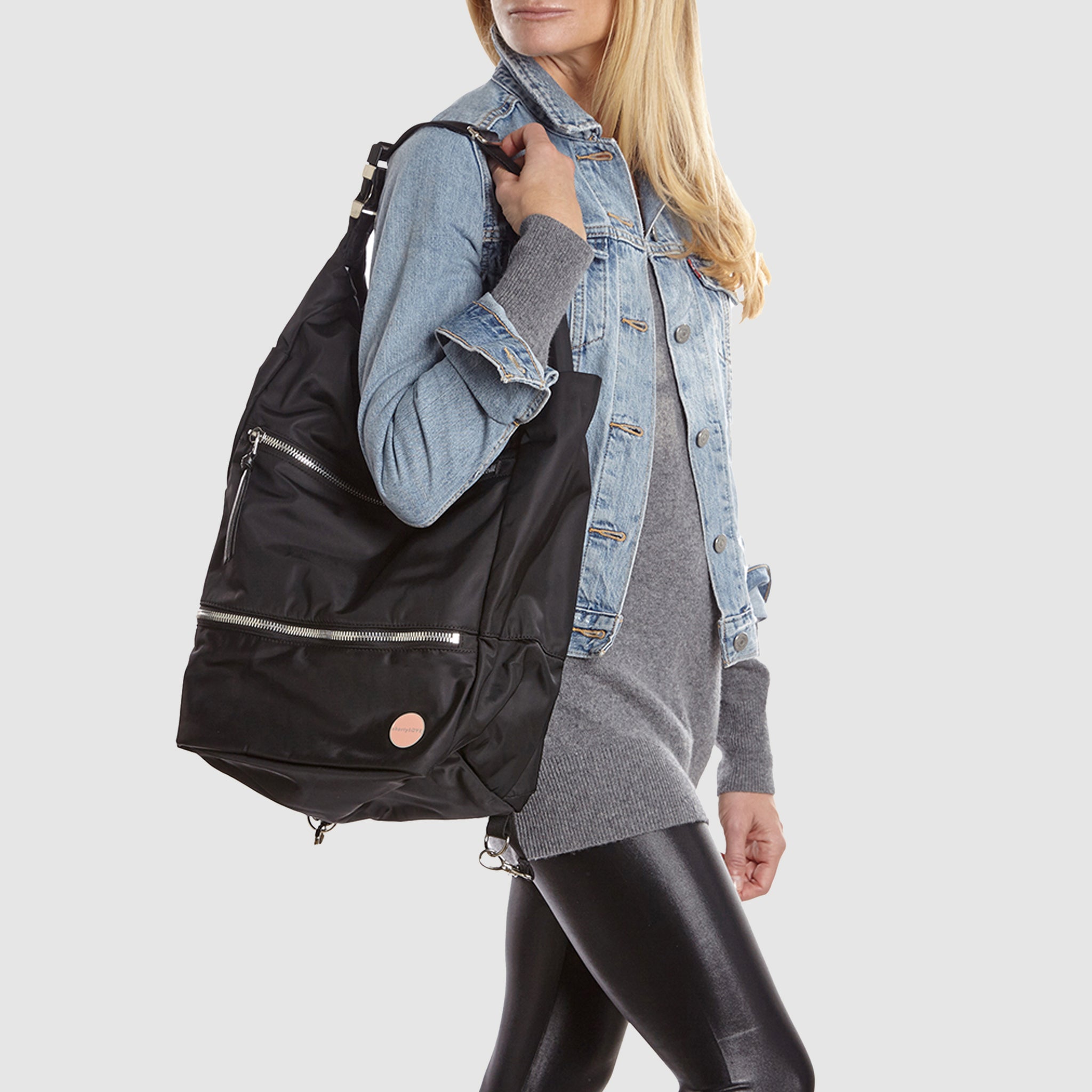 shortyLOVE boxer backpack bag in black; on model in blue jean jacket and black leggings against white background.