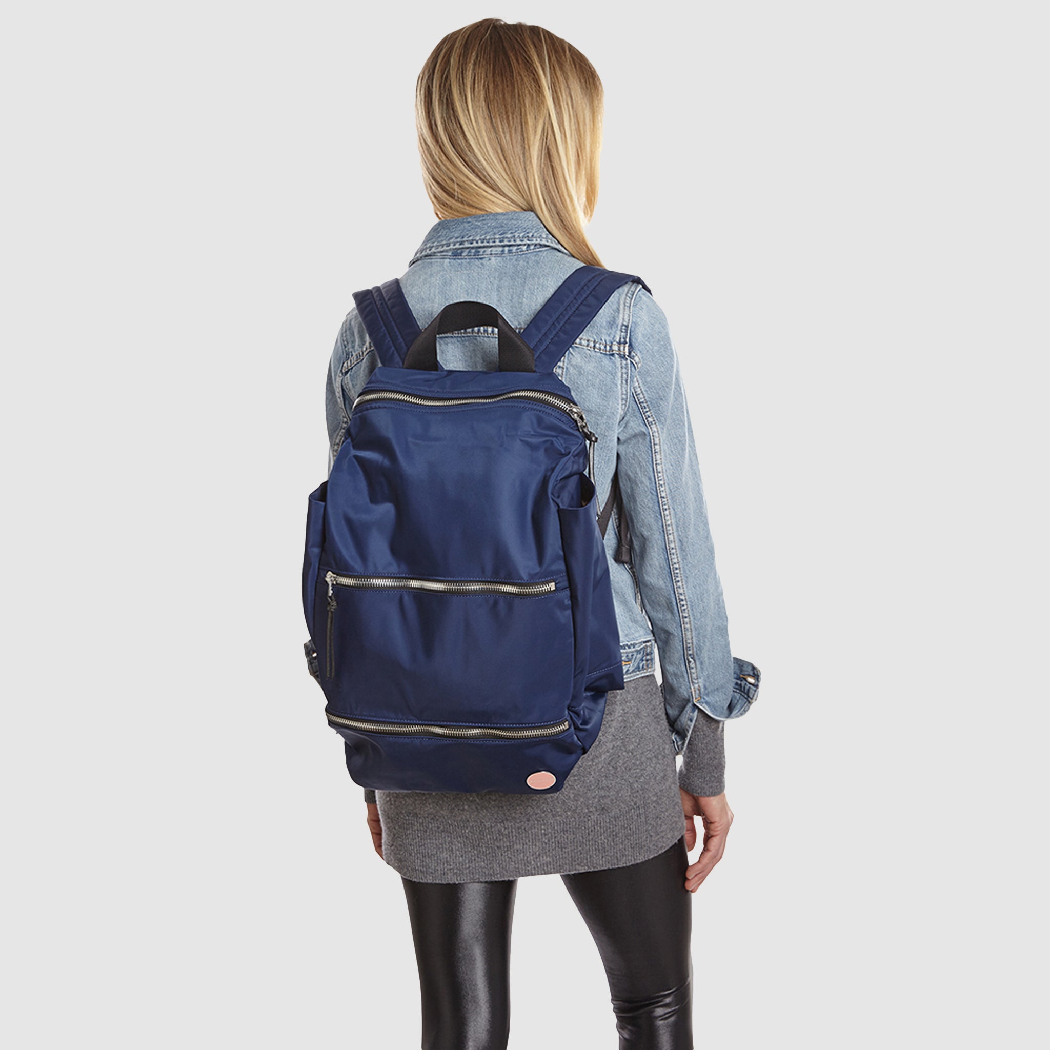 shortyLOVE boxer backpack bag in navy; on model in jean jacket and black leggings