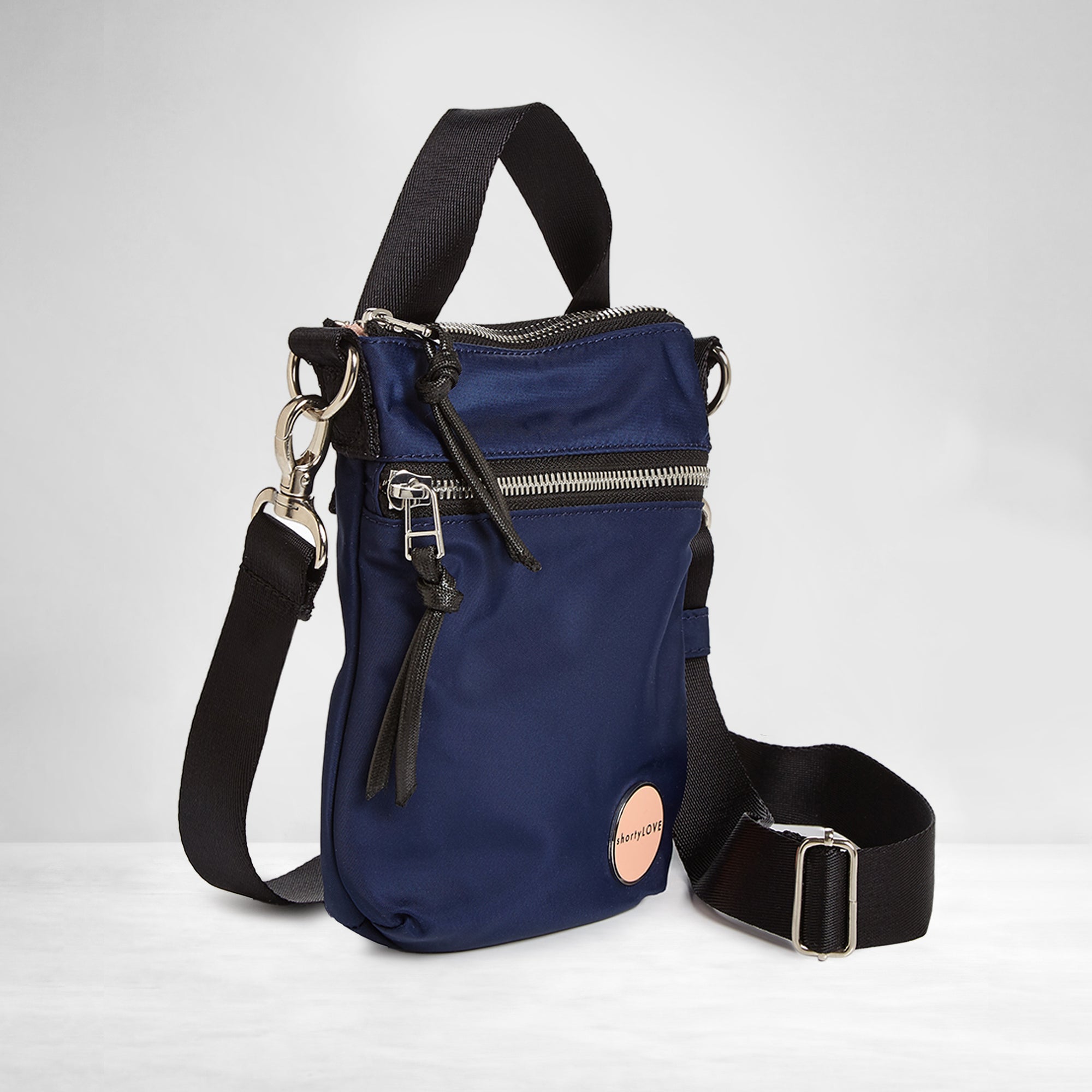 shortyLOVE shorthand crossbody phone bag in navy; side angle view against white background.