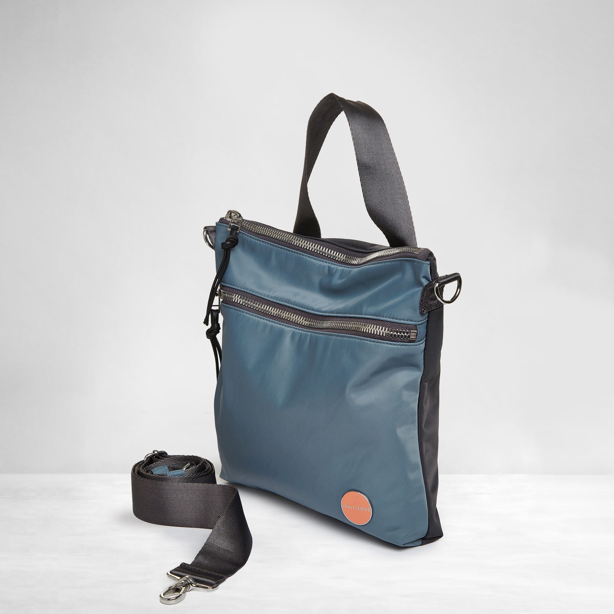 shortyLOVE amuse medium sized crossbody bag in steel blue/charcoal;side view against white background.