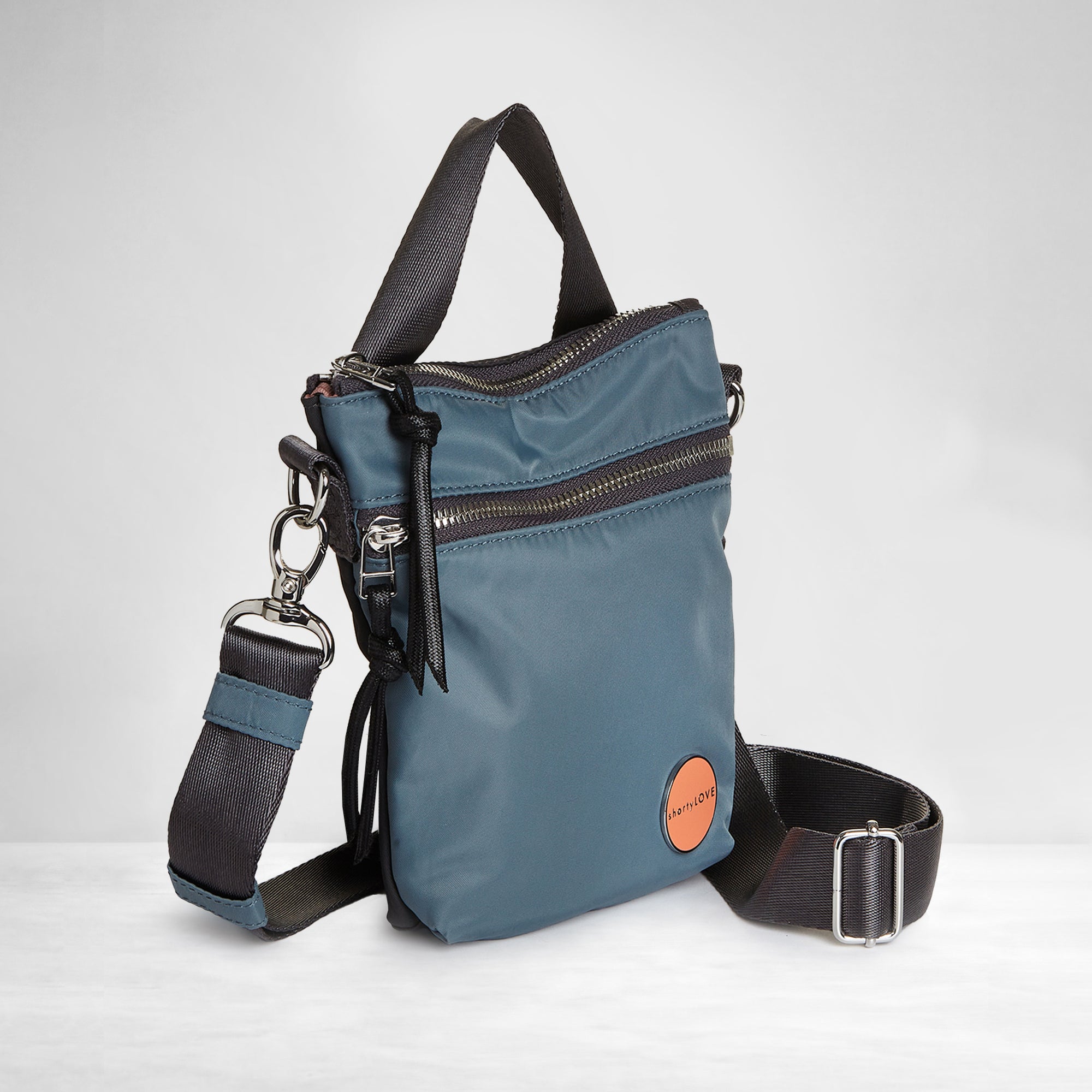 shortyLOVE shorthand small crossbody bag in steel blue/charcoal; side view against white background.