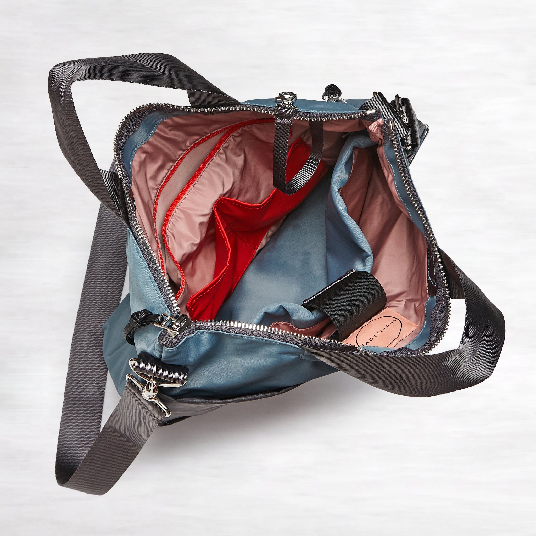 shortyLOVE wonder large crossbody/messenger bag in steel blue/charcoal; top-down view showing interior steel blue/charcoal lining against white background.