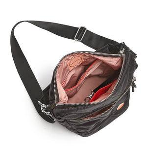 shortyLOVE marcel crossbody bucket bag in black; top-down view showing interior blush lining against white background.