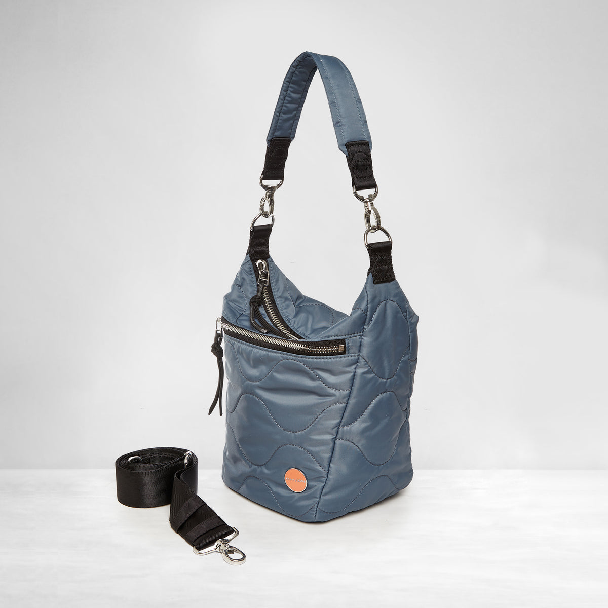 shortyLOVE marcel crossbody bucket bag in steel blue; side view against white background.