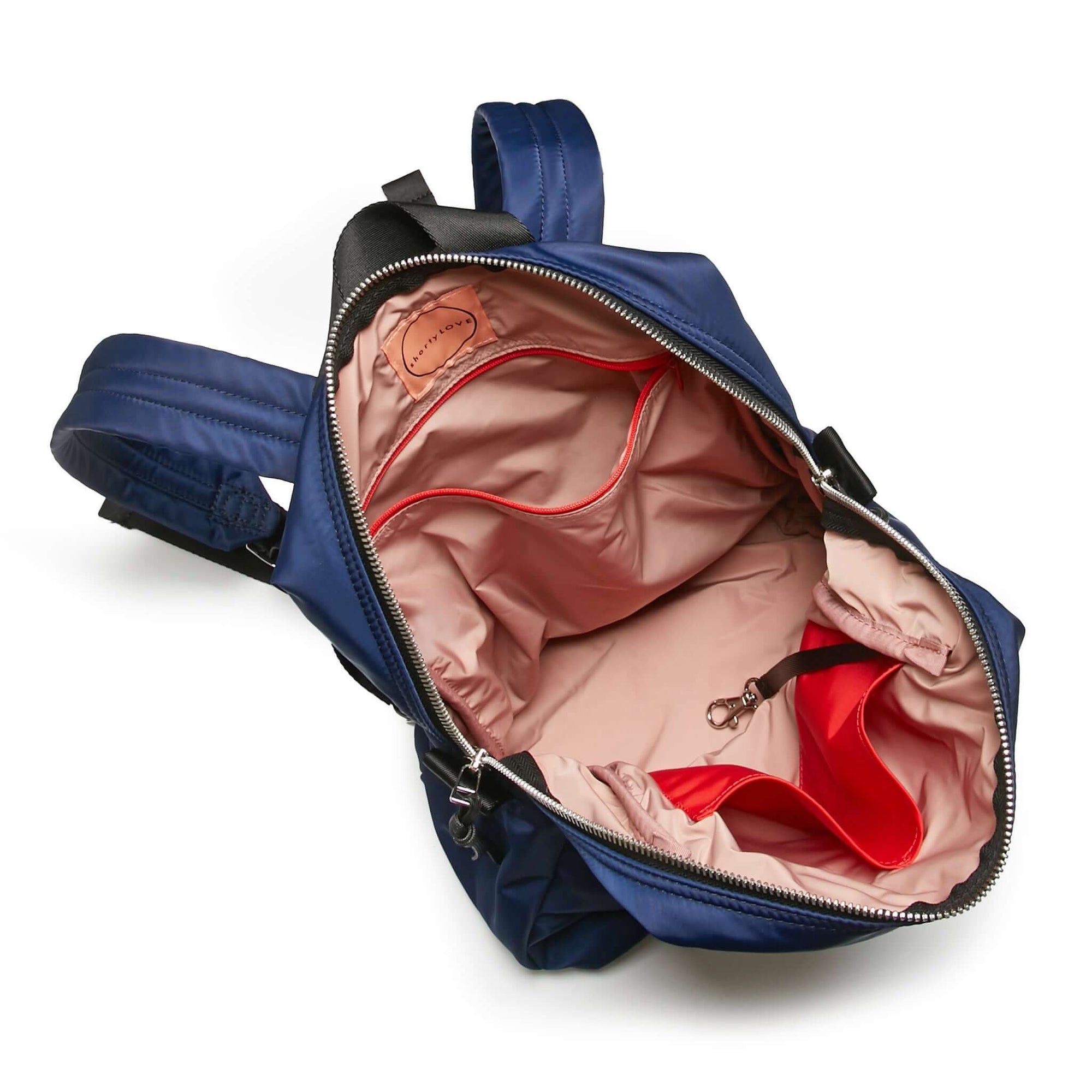 shortyLOVE ace small backpack in navy; top-down view showing interior pink lining against white background.