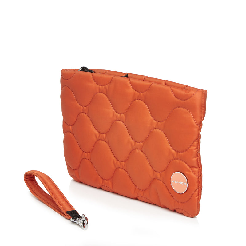 shortyLOVE cleo wristlet clutch in orange; side view against white background.