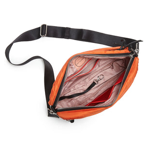 shortyLOVE cruiser medium crossbody bag in orange; top-down view showing interior blush lining against white background.