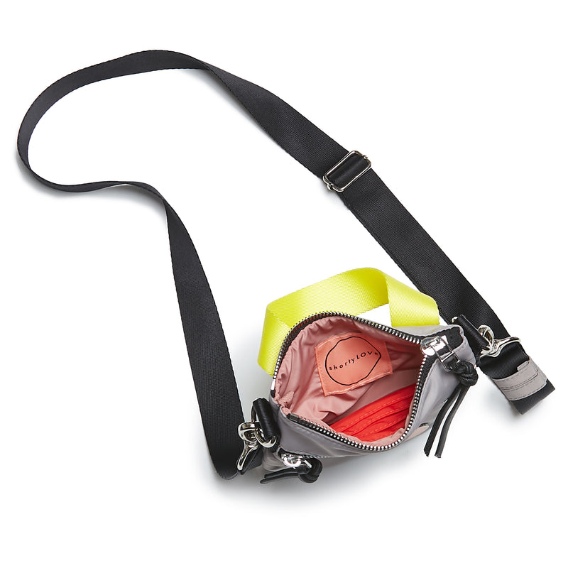 shortyLOVE shorthand small crossbody bag in grey; top-down view showing interior blush lining against white background.