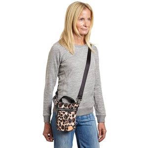 shortyLOVE shorthand small crossbody bag in leopard; on model in grey sweatshirt and jeans against white background.