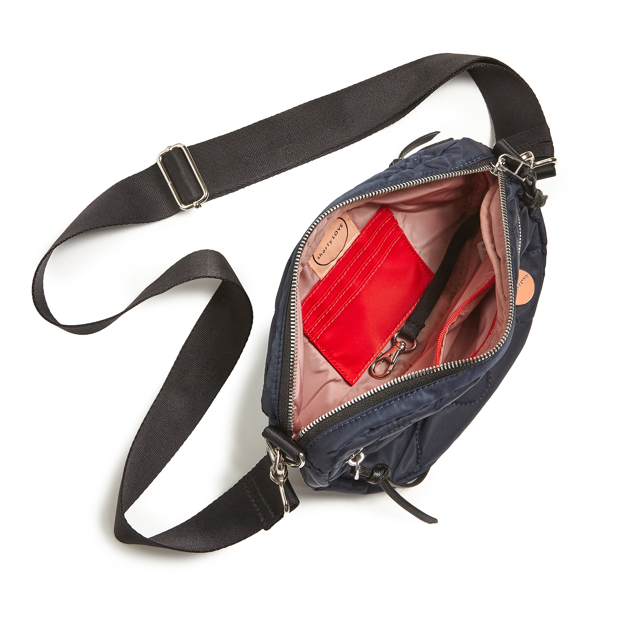shortyLOVE small cruiser small crossbody bag in midnight; top-down view showing interior blush lining against white background.