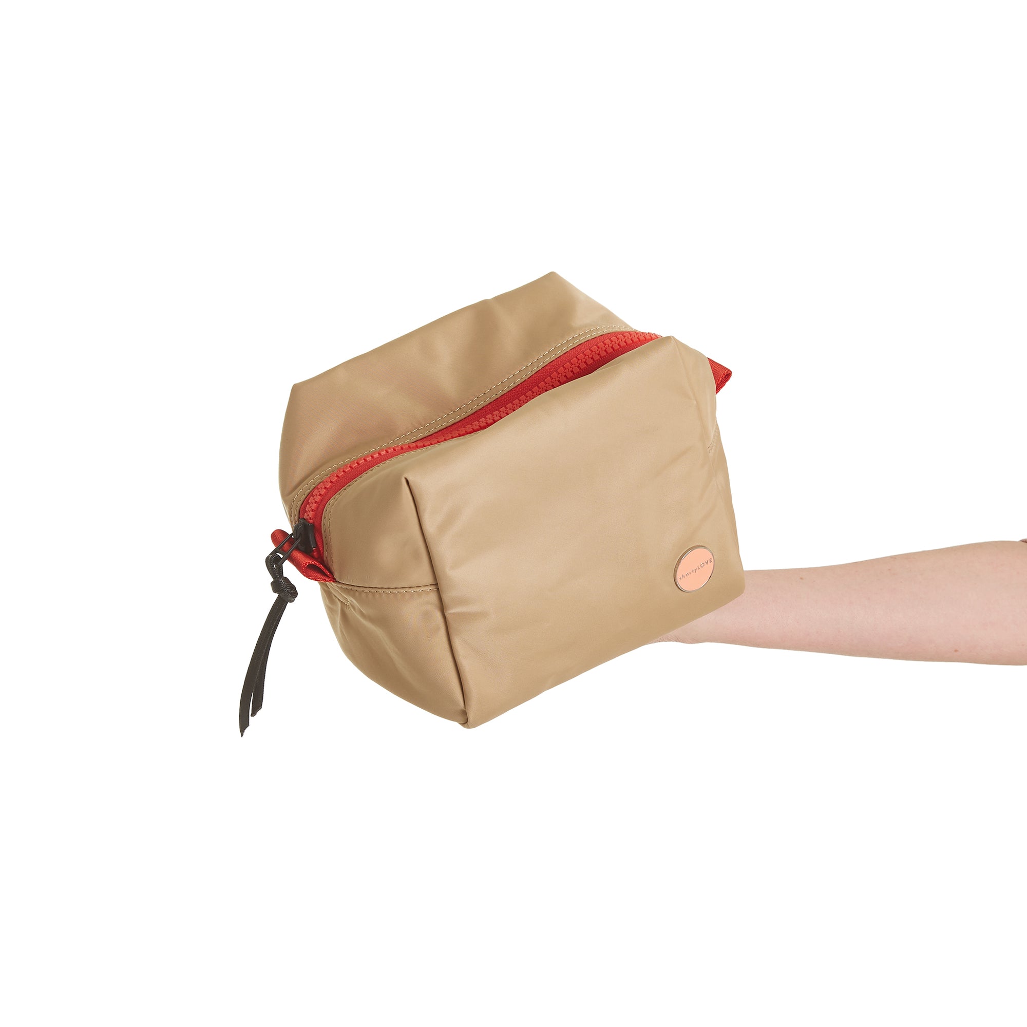 shortyLOVE stevie cosmetic bag in khaki; hand held by model against white background.