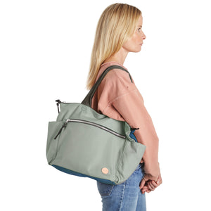 shortyLOVE tillie tote bag in slate/teal on model in jeans against white background.