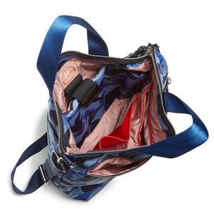 shortyLOVE wonder large crossbody/messenger bag in blue camo; top-down view showing interior blush lining against white background.