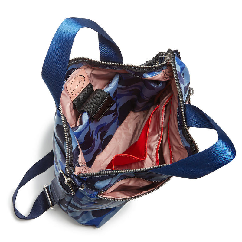 shortyLOVE wonder large crossbody/messenger bag in blue camo; top-down view showing interior blush lining against white background.